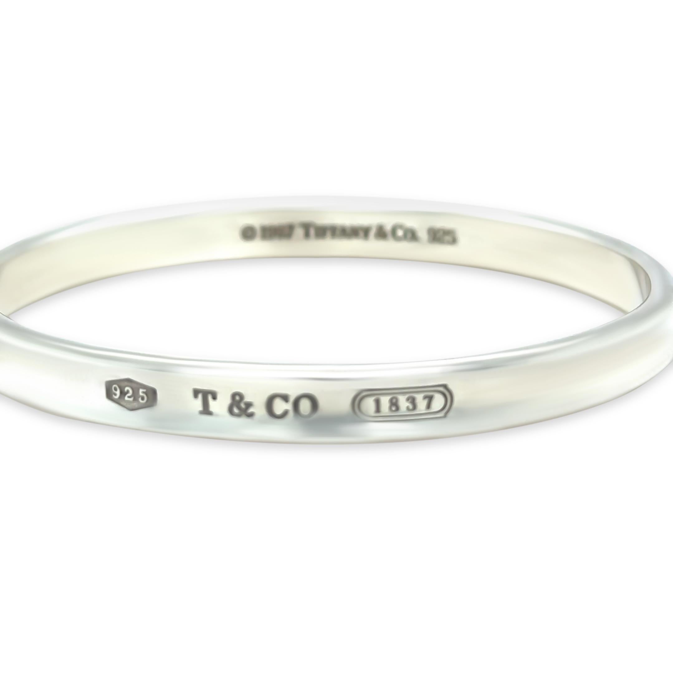 This sleek and polished Tiffany & Co. 1837 narrow bracelet is crafted in sterling silver, featuring the elegant curved profile and engraved branding that defines the iconic 1837 collection. A versatile piece that balances minimalism and