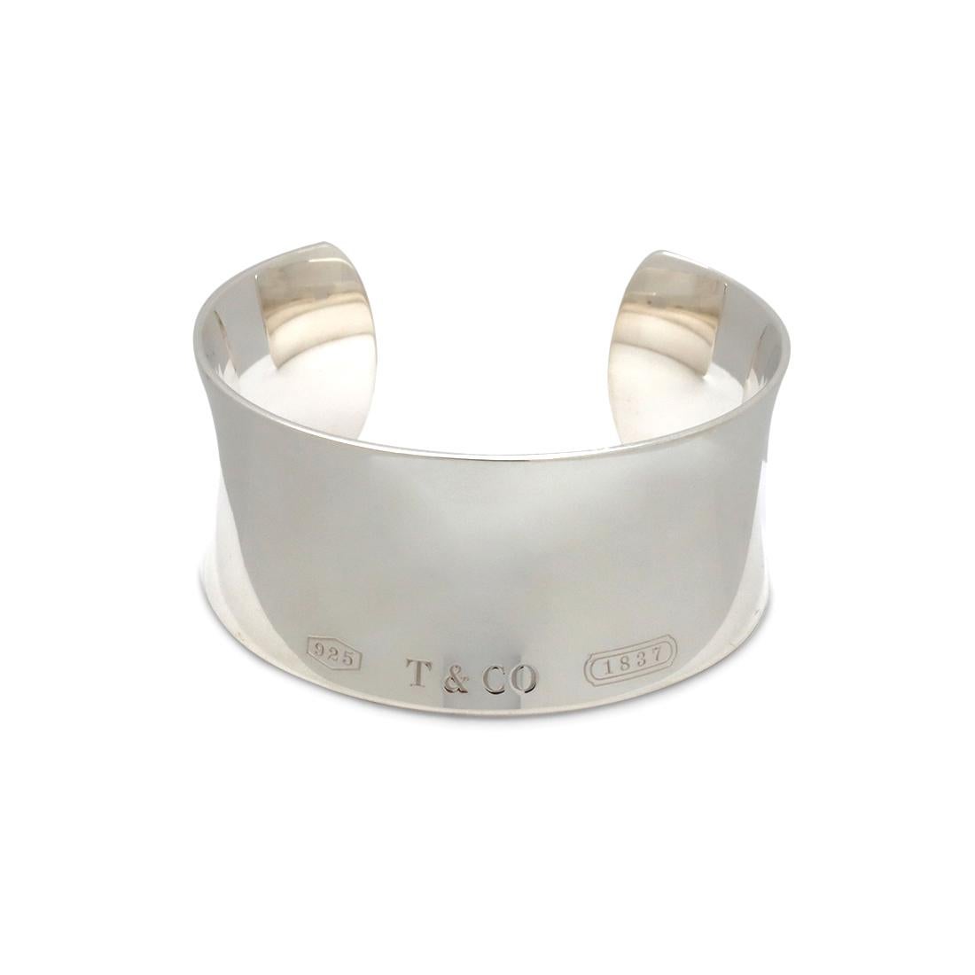 Authentic Tiffany & Co. cuff crafted in sterling silver. The bracelet highlights 925, T & CO signature and 1837 along the bottom surface of the cuff as a design. The bracelet width is 30.5mm. Stamped 925 and signed Tiffany & Co. on the inside. US