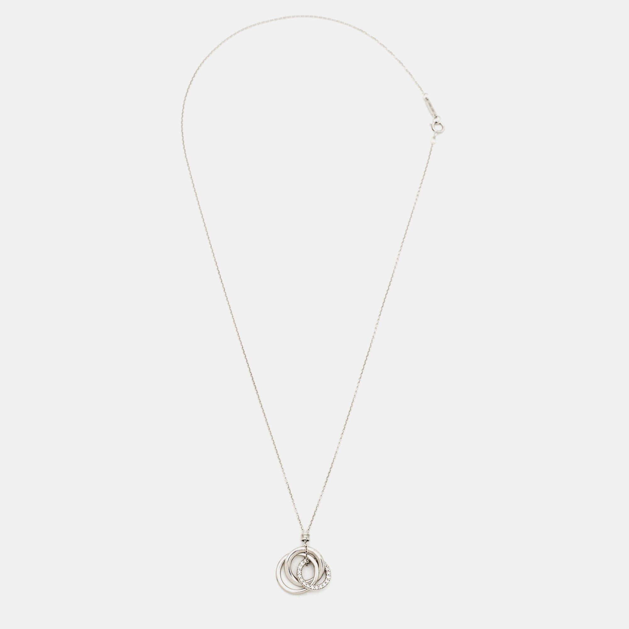 We'd love this Tiffany & Co. piece to complement our everyday style. The 18k white gold necklace comes with a pendant of three interlocking rings, one of which is embellished with diamonds.

Includes
Original Box, Original Case