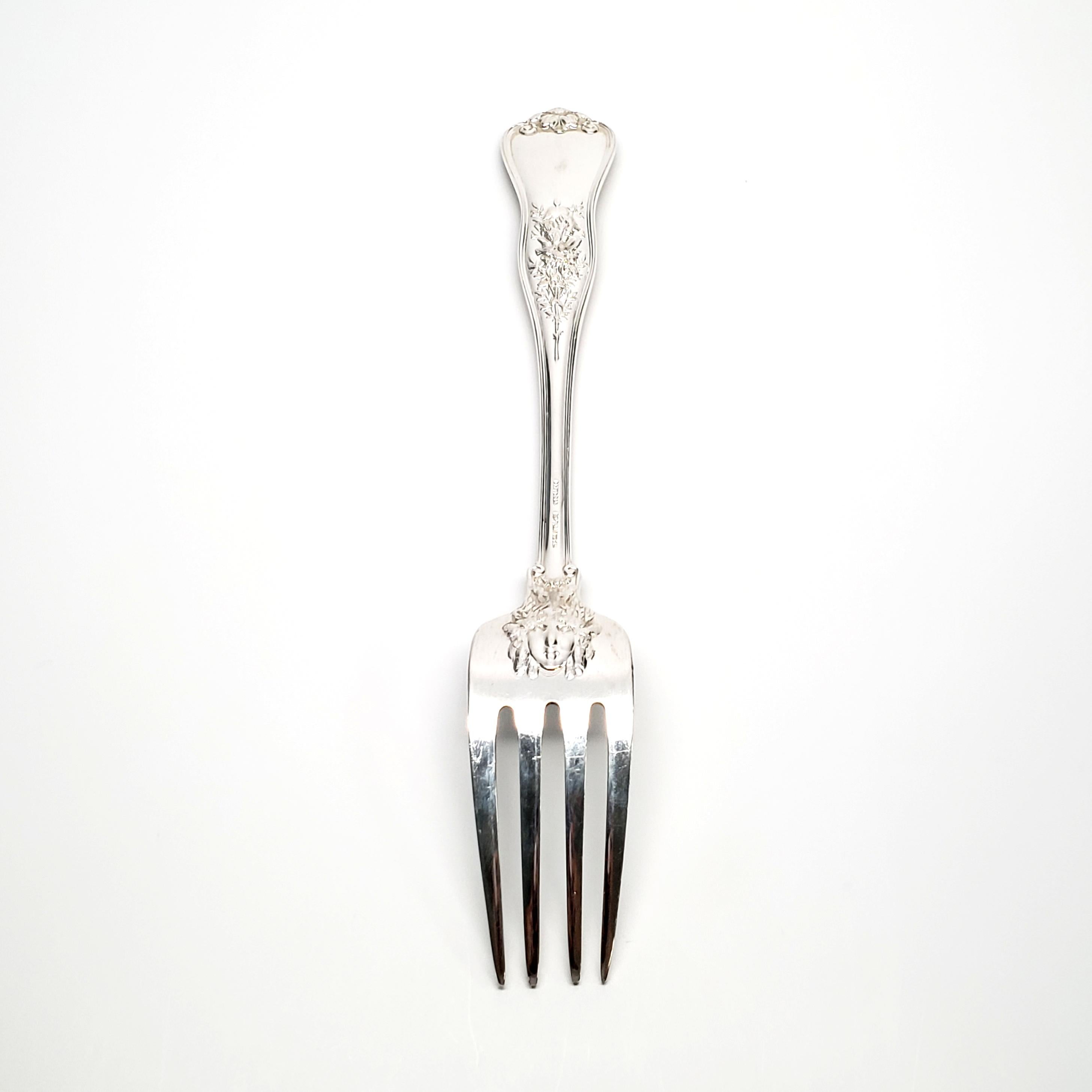 Vintage Tiffany & Co. sterling silver serving fork in the Olympian 1878 pattern.

Olympian is an ornate and elaborate multi-motif pattern, featuring 17 different sharply carved handle decorations depicting scenes from Classical Mythology.