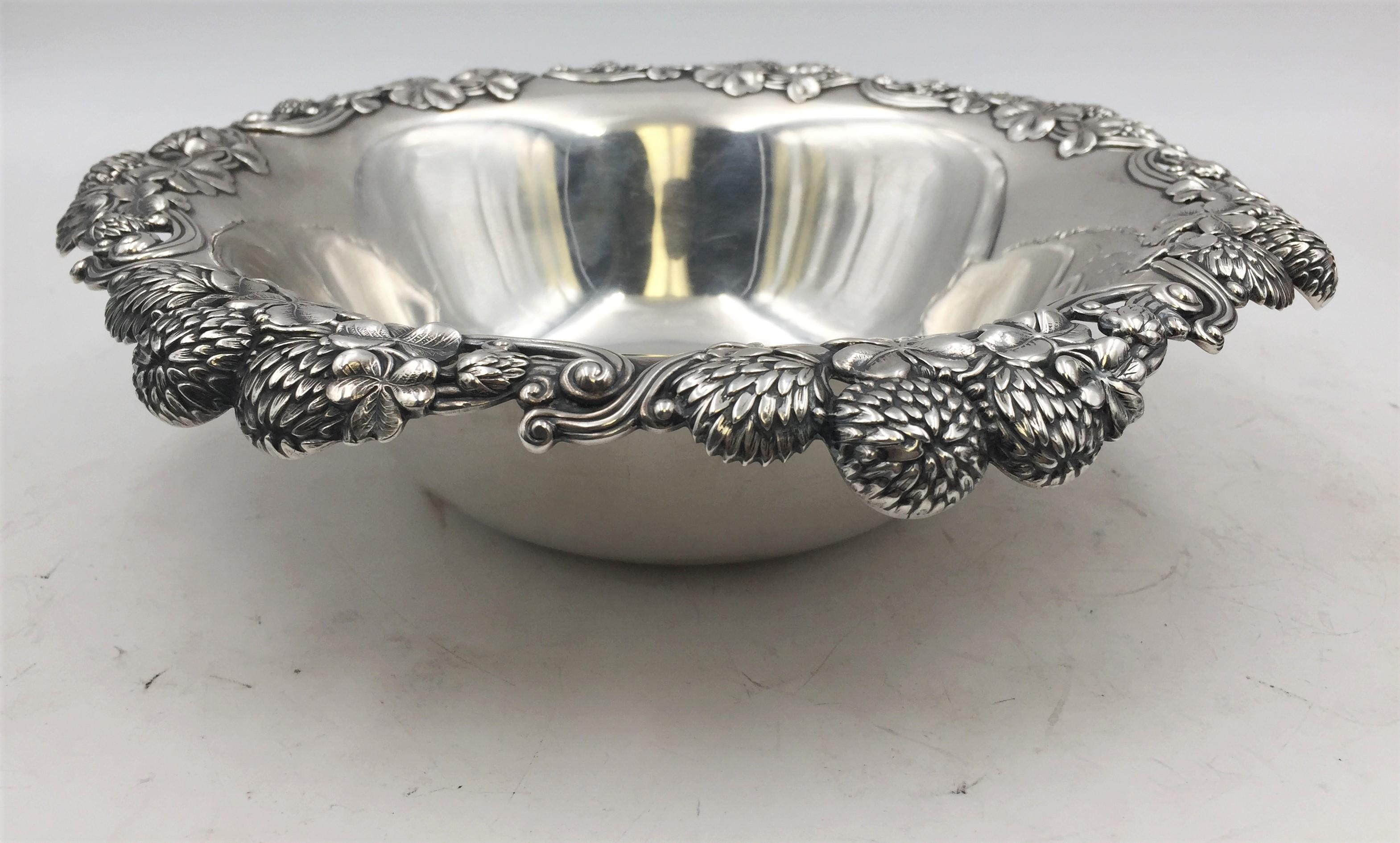Tiffany & Co. sterling silver berry bowl in Art Nouveau style and in Clover pattern in pattern 13780 from 1898 with exquisite applied motifs around the rim. It measures 10” in diameter by 2 ¾” in height, weighs 16.8 ozt, and bears hallmarks and
