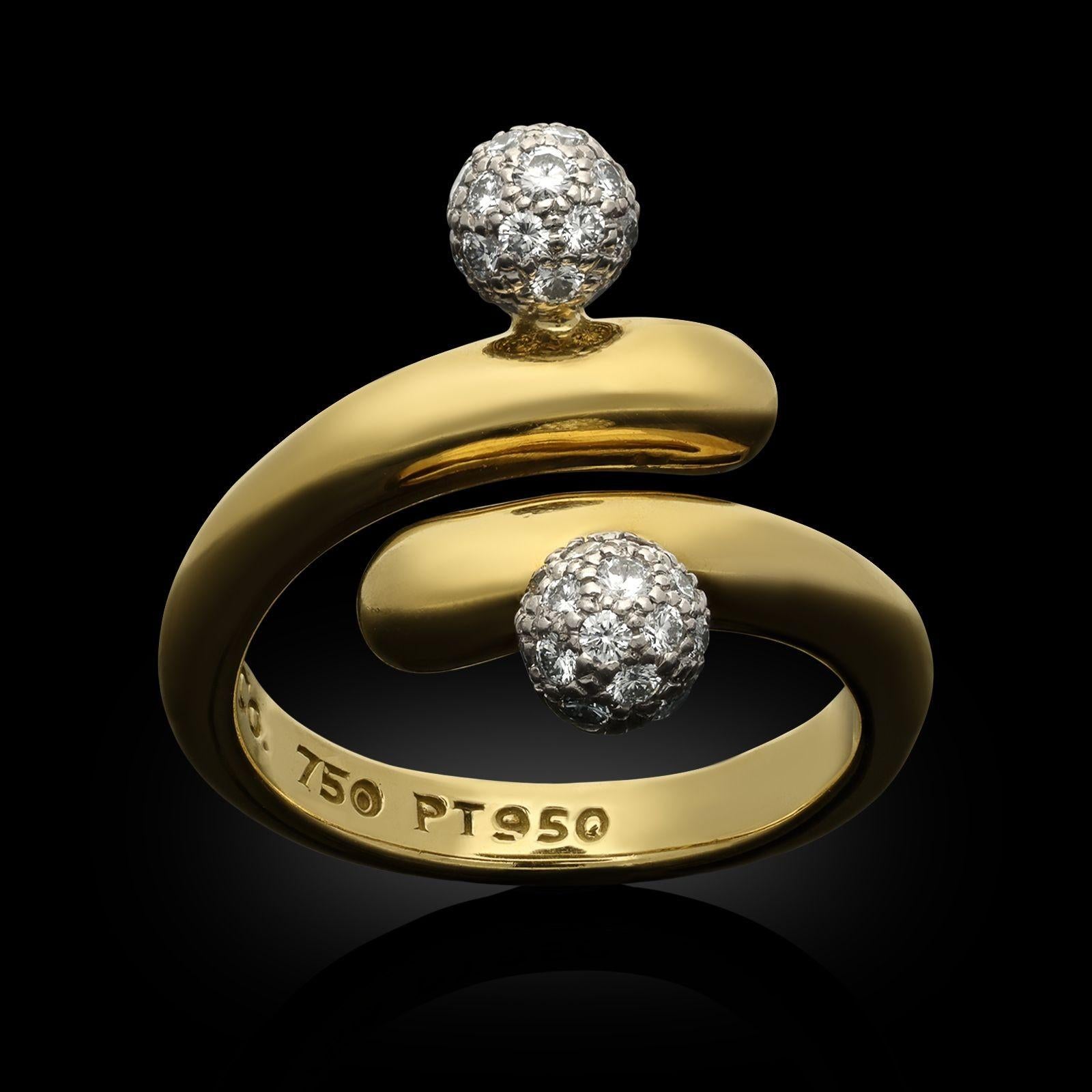 A vintage 18ct yellow gold and diamond crossover ring by Tiffany & Co. circa 1980. The ring is designed as a stylised crossover with two diamond pavé set three dimensional platinum spherical accents on the overlapping yellow gold band.
Maker
Tiffany