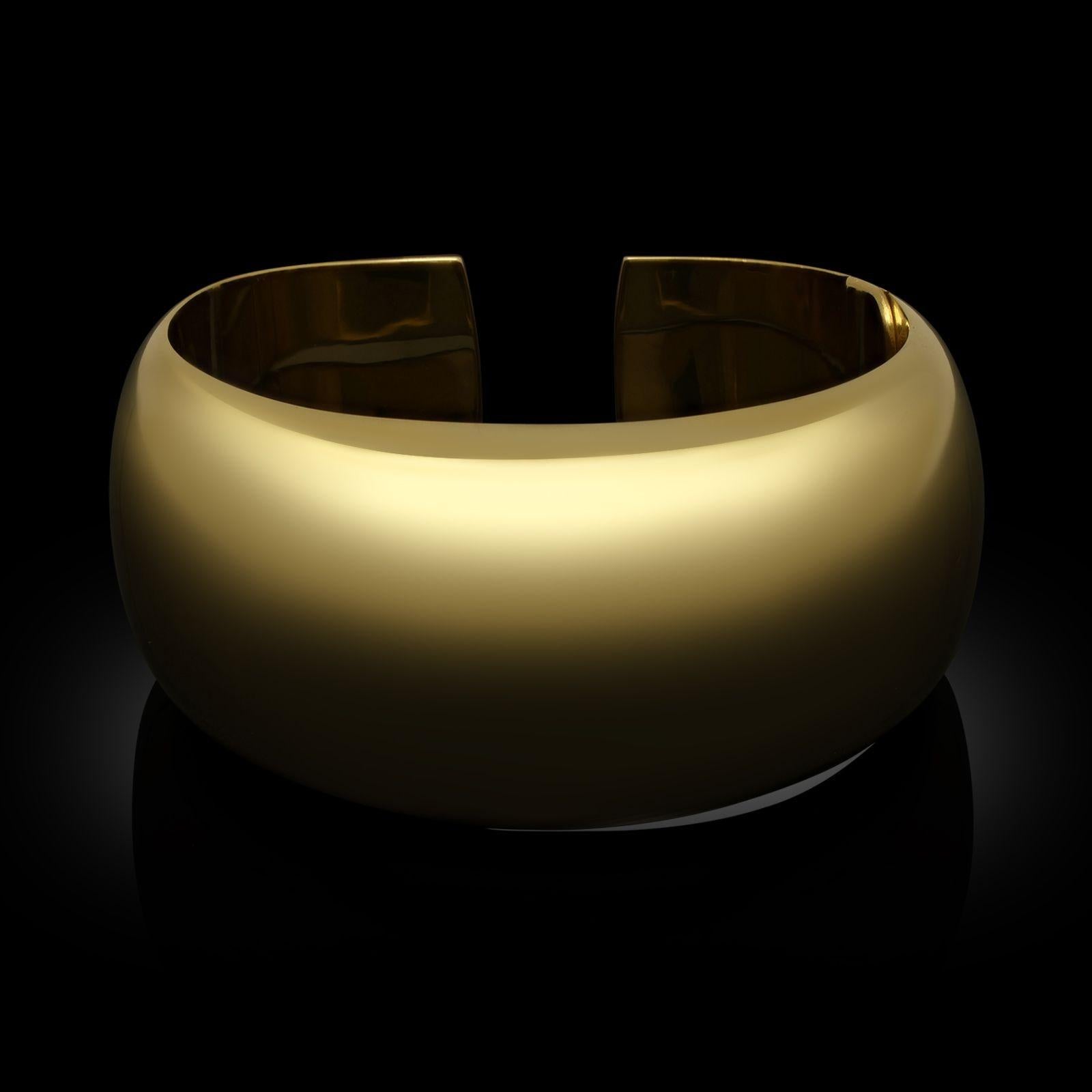 A gold cuff bracelet made by Carlo Weingrill for Tiffany & Co. circa 2000. The cuff is designed with a domed profile that tapers to the back, all in polished 18ct yellow gold and with a discreet hinge to one side.
Maker
Tiffany & Co. made by Carlo