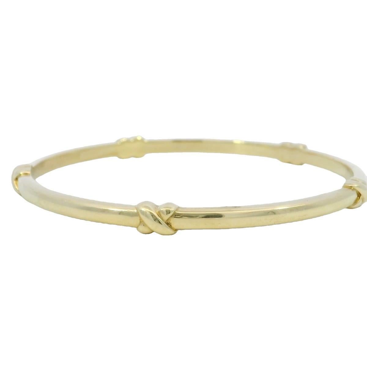 Tiffany & Co. 18K Yellow Gold Knot Bangle Bracelet

The Tiffany & Co. bangle showcases a sleek, polished design with subtle knot accents that add a touch of elegance. Made in 18K yellow gold, the bracelet's smooth surface reflects light beautifully,