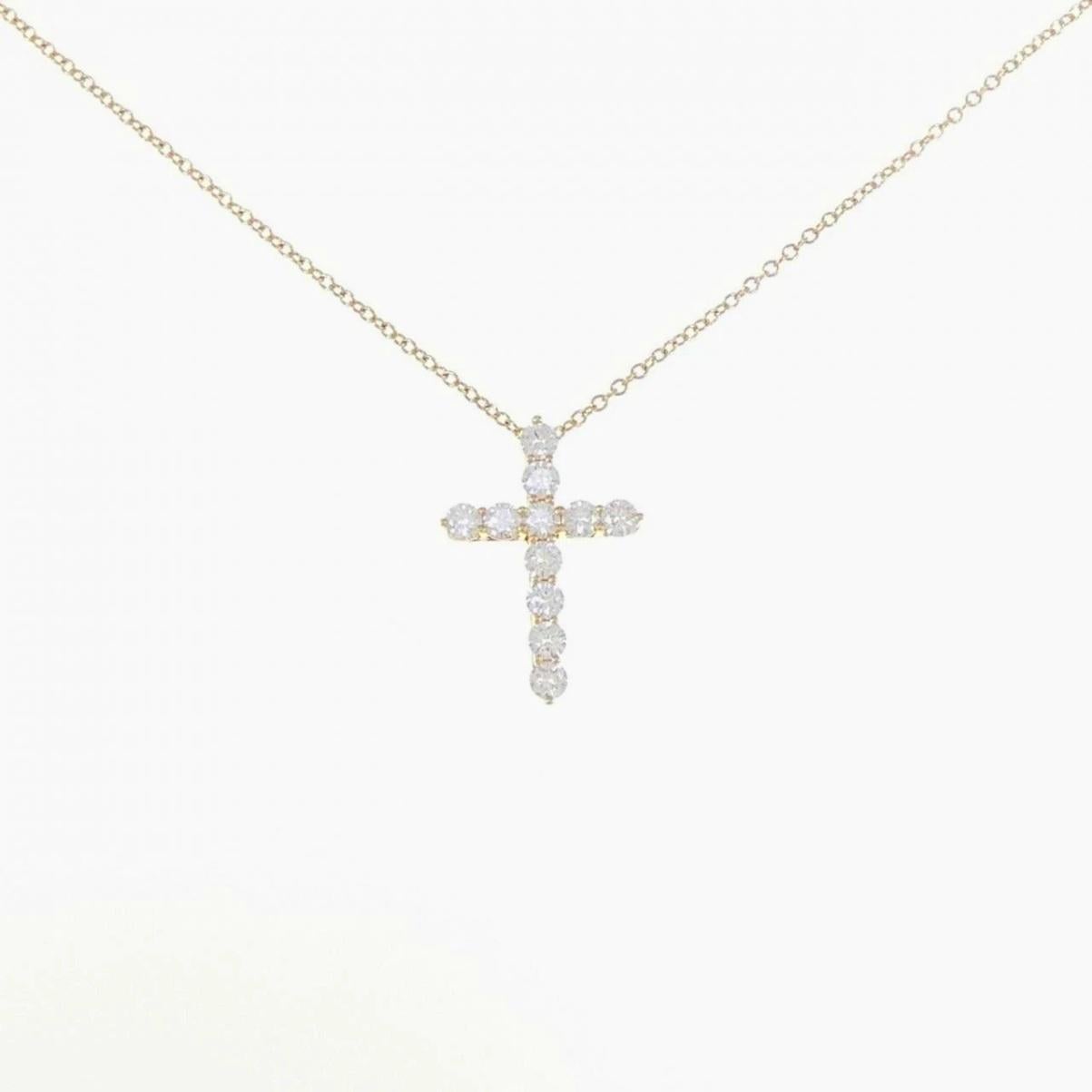 Taille ronde TIFFANY & Co. Collier pendentif croix en or 18K avec diamant de 0,42ct en vente