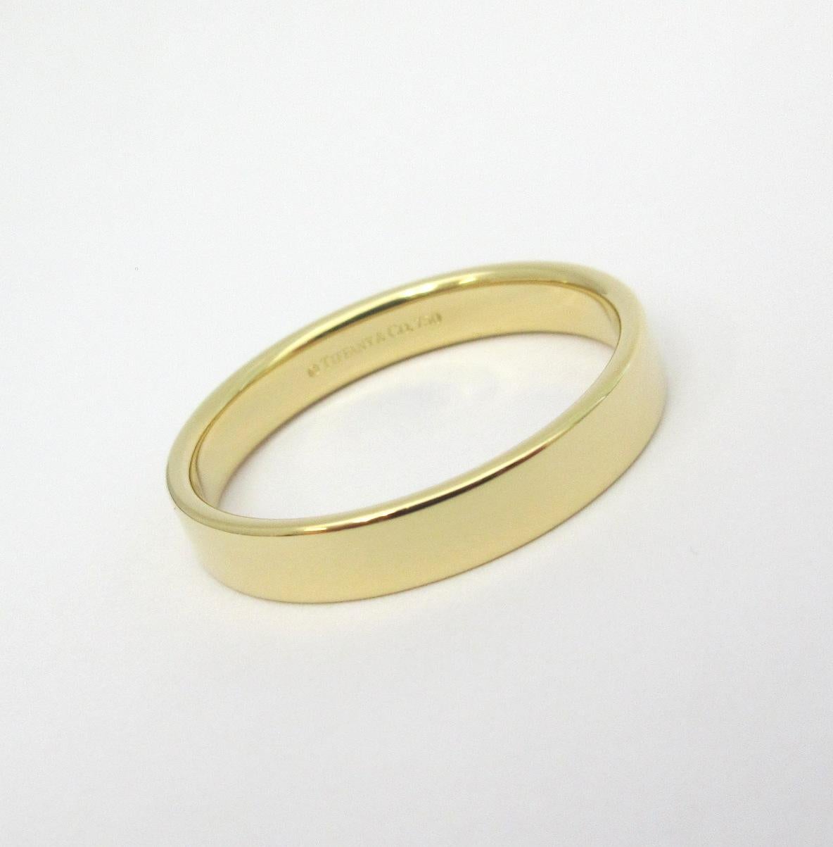 TIFFANY & Co. 18K Gold 4mm Essential Flat Wedding Band Ring 11.5

Metal: 18K Gold 
Size: 11.5 
Band Width: 4mm
Weight: 6.0 grams
Hallmark: ©TIFFANY&CO. 750
Condition: New, comes with Tiffany pouch and box 

Limited edition, no longer available for