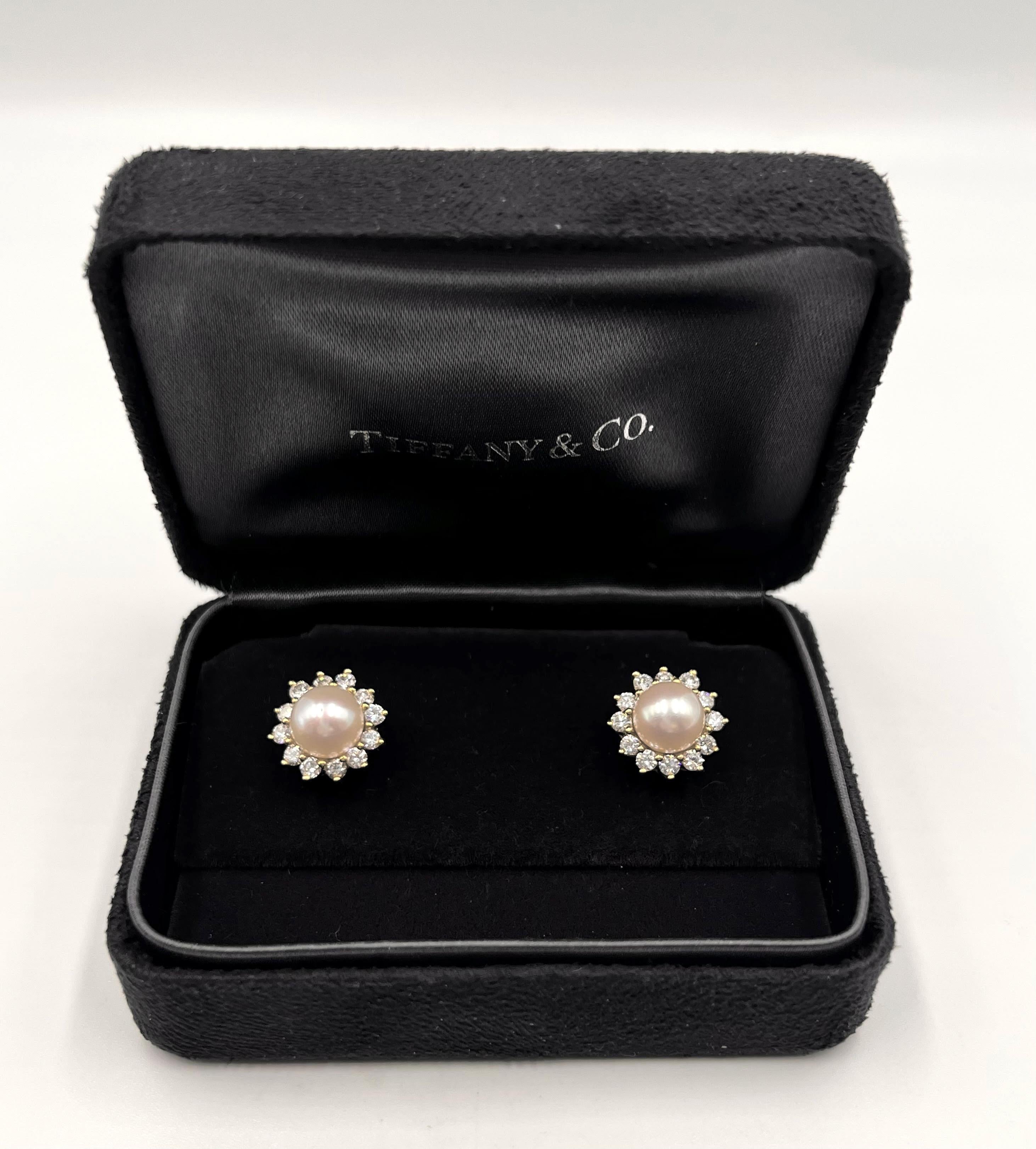 Tiffany & Co. 18k yellow gold earrings each set with an 8mm Akoya saltwater cultured pearl displaying a pink-rose overtone and beautiful high luster.  Surrounded by twenty-four round brilliant-cut diamonds weighing approximately 1.00 total carats