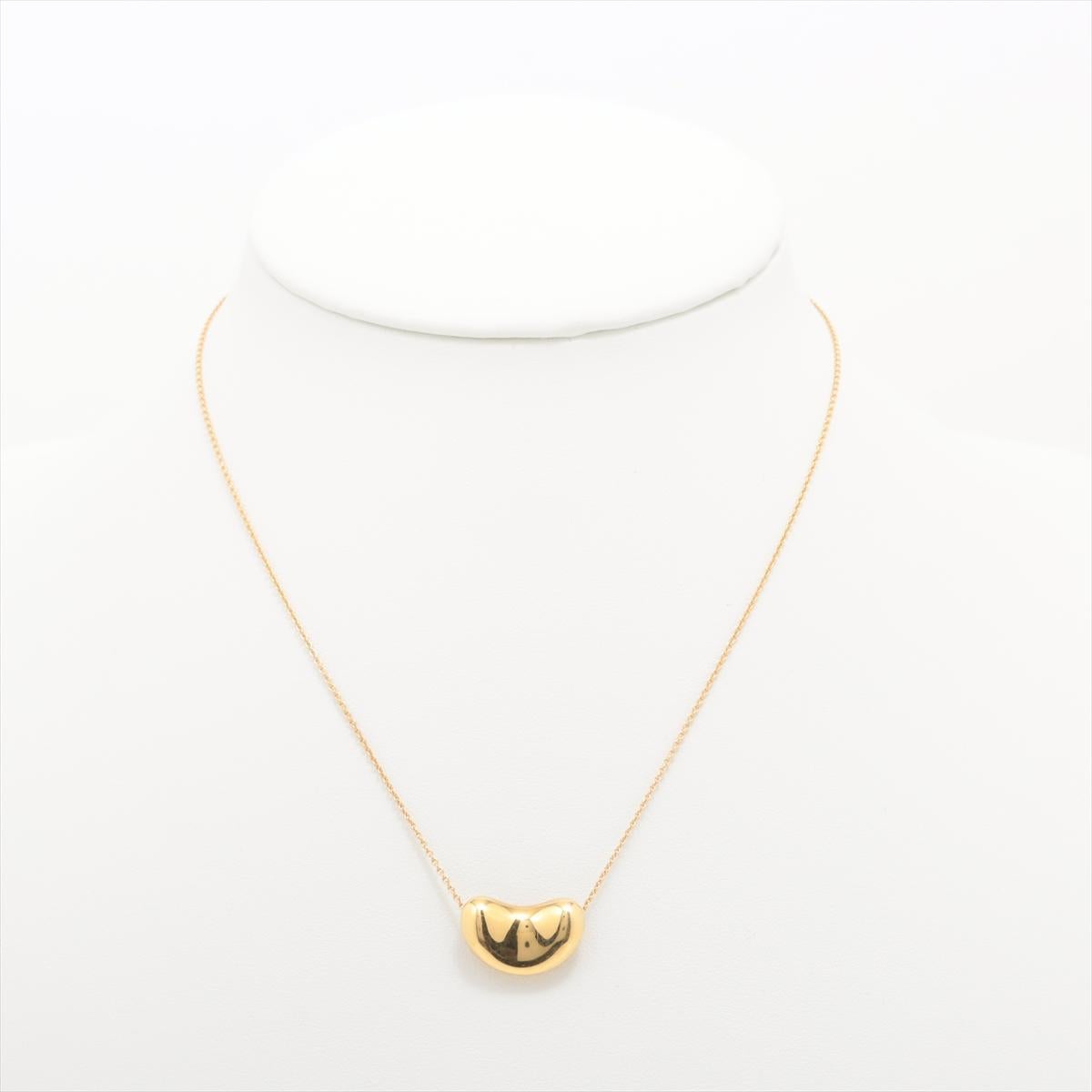 Lovely Find. PRE-OWNED 18kt Yellow Gold pendant with 18kt Yellow Gold Chain.
The piece is designed by Elsa Peretti and made by Tiffany & Co.

18k 750 Bean Pendant.

Chain is marked 750, Tiffany & Co., Spain, Peretti. 16 inches in length.
Will come