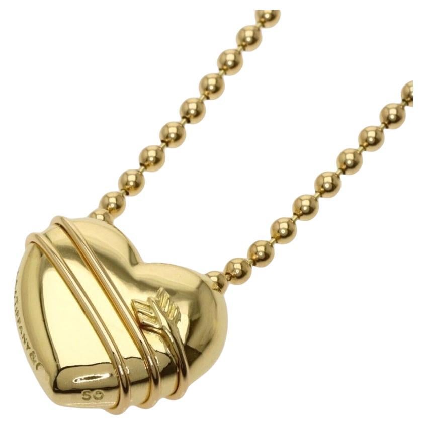TIFFANY
Co. 18K Gold Cupid Arrow Heart Pendant Beaded Chain Necklace
