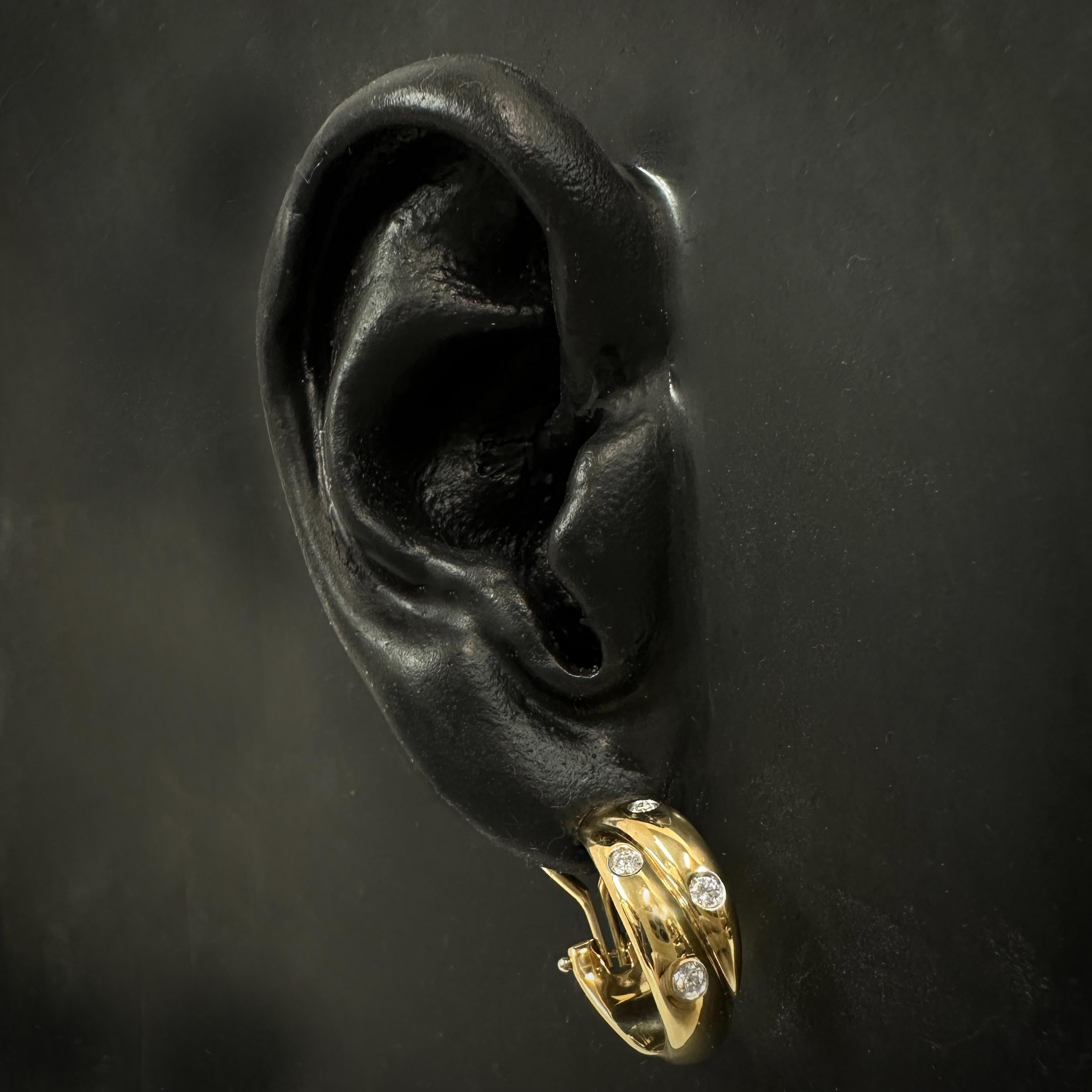 This design, probably introduced in the 1980's or 1990's, was retired in the early 2000's in favor of a more straightforward thick hoop (with no two-strand detail).  The same Etoile sensibility -- elegant, scrupulously well-made jewelry that can be