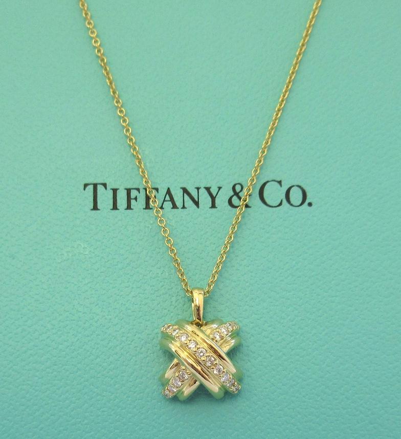 TIFFANY & Co. 18K Gold Diamond Signature X Pendant Necklace

Metal: 18K Yellow Gold 
Weight: 4.50 grams  
Chain: 16