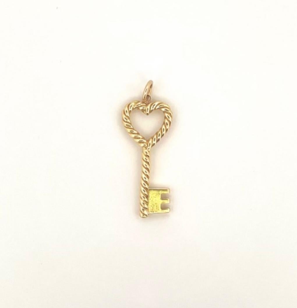 DESIGNER: Tiffany & Co.
CIRCA: 1980’s
MATERIALS: 18k Yellow Gold
WEIGHT: 7.1 grams
MEASUREMENTS: 1- 3/8” x 3/8”
HALLMARKS: Tiffany & Co, 18K
ITEM DETAILS:
Tiffany & Co. 18k Gold Heart Key Pendant

A sweet 18k gold Heart Key pendant by Tiffany &