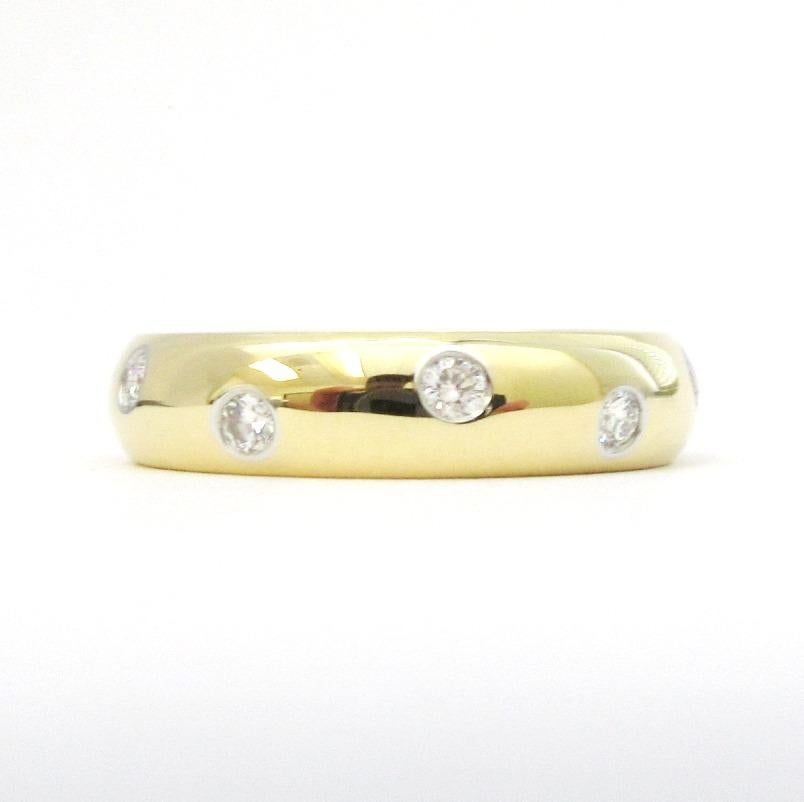 TIFFANY & Co. 18K Gold Platinum Diamond Etoile Band Ring 5

Metal: 18K Gold and platinum 
Size: 5 
Band Width: 4mm
Diamond: 10 round brilliant diamonds, carat total weight .22
Hallmark: T&CO. 750 PT950 
Condition: Excellent condition, like new. It