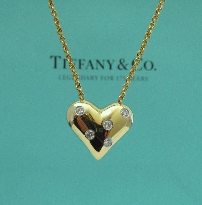 TIFFANY & Co. 18K Gold Platinum Etoile 5 Diamond Heart Pendant Necklace

Metal: 18K yellow Gold and Platinum
Weight: 9.30 grams
Chain: 16
