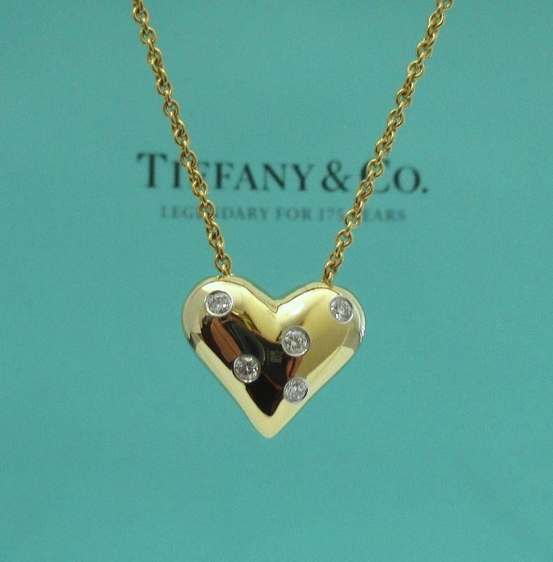 TIFFANY & Co. 18K Gold Platinum Etoile 5 Diamond Heart Pendant Necklace

Metal: 18K yellow Gold and Platinum
Weight: 9.40 grams
Chain: 16