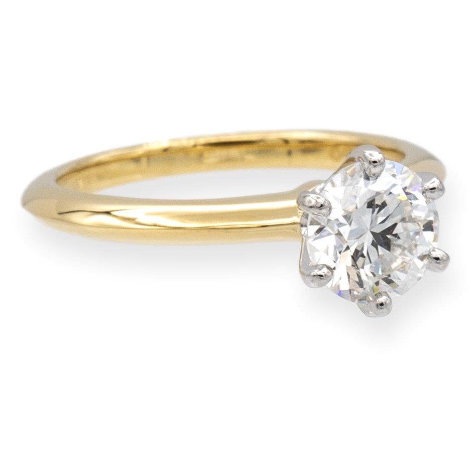 Tiffany & Co. classic solitaire engagement ring finely crafted in 18 karat yellow gold featuring a round brilliant diamond center weighing 1.09 carats I color , Very Fine IF ( Internally Flawless) clarity set in a platinum 6 prong basket setting.