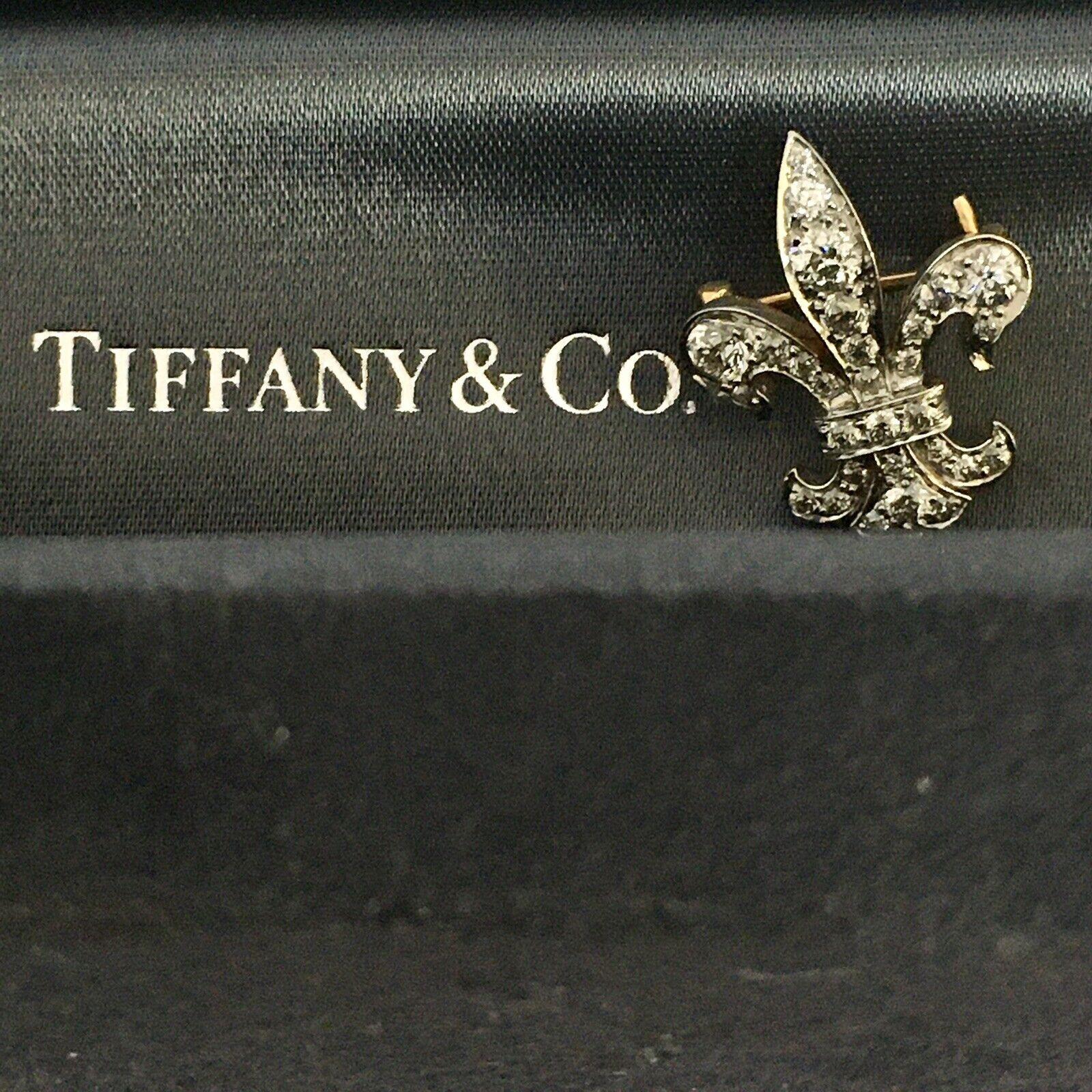 An antique, Edwardian/late Victorian era, Fleur-de-Lis brooch marked Tiffany & Co, set with Old European Cut Diamonds weighing approximately O.75- 1.00 total Carat weight, the largest Diamond weighing approximately 0.20 Carat, mounted on Platinum