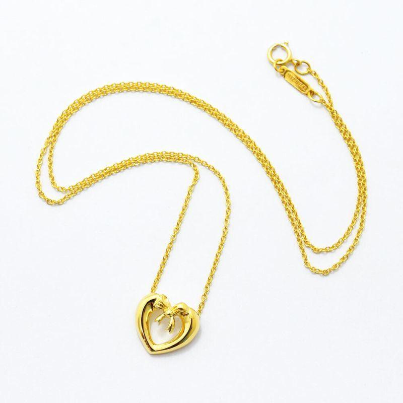TIFFANY & Co. Collier pendentif cœur en or 18 carats avec ruban et nœud en vente 4