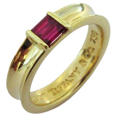 TIFFANY & Co. 18K Yellow Gold Ruby Stacking Ring 5.5

Metal: 18K yellow gold
Size: 5.5
Band Width: 4.5mm
Ruby: two emerald cut rubies, carat total weight .30
Hallmark: ©1997 TIFFANY & Co. 750
Condition: perfect condition

Authenticity Guaranteed