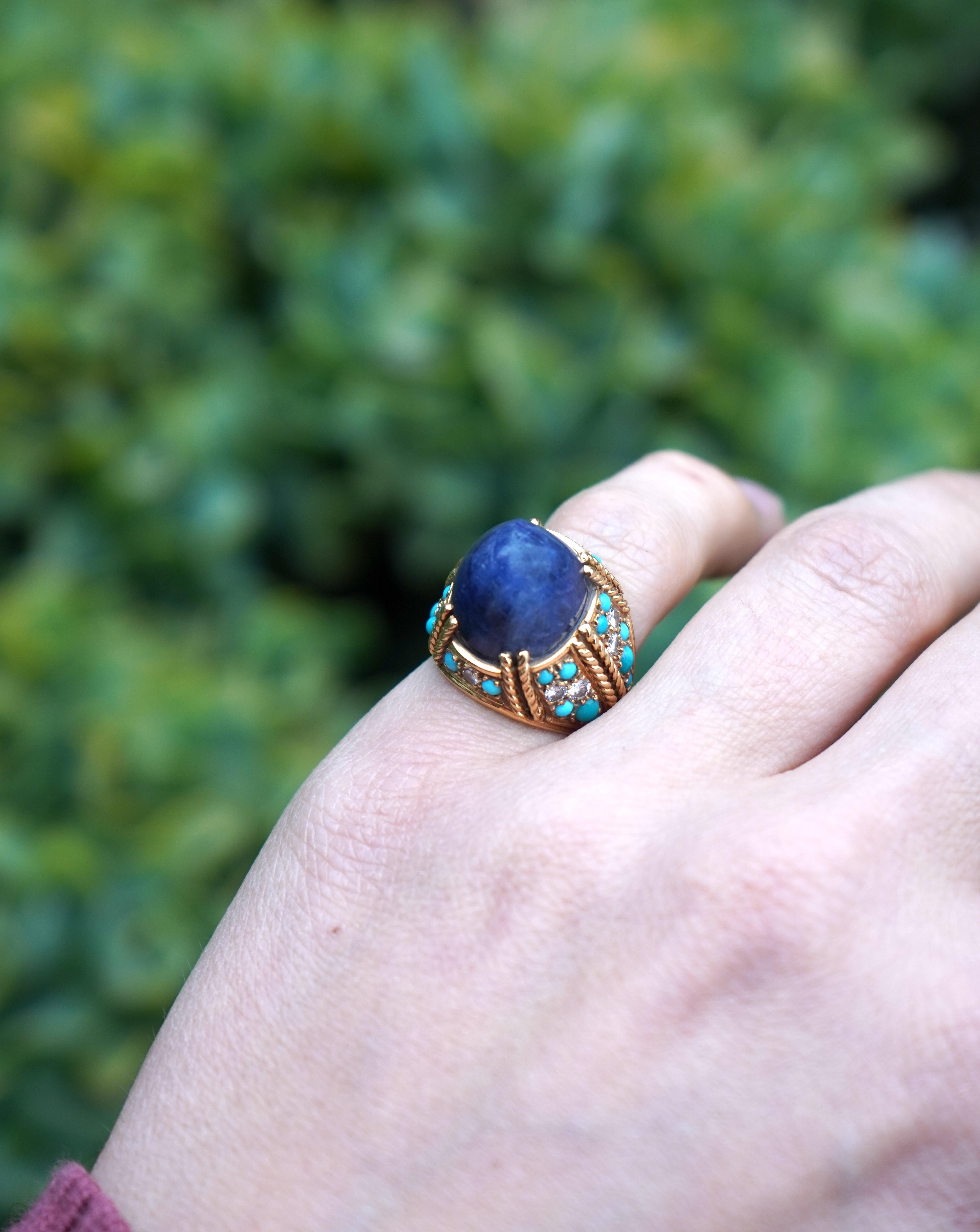 This Tiffany & Co. ring from the 1980s is crafted in 18k gold and features a bold design featuring a cabochon sodalite stone. The deep blue sodalite is bezel-set, creating a smooth and polished focal point. Surrounding the center stone, the gold