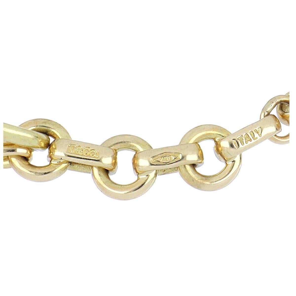 Estate modern Tiffany & Co. 18K yellow gold link bracelet with five atlas charms. Circa 2010. This bracelet is 7 1/2 inches in length. 
