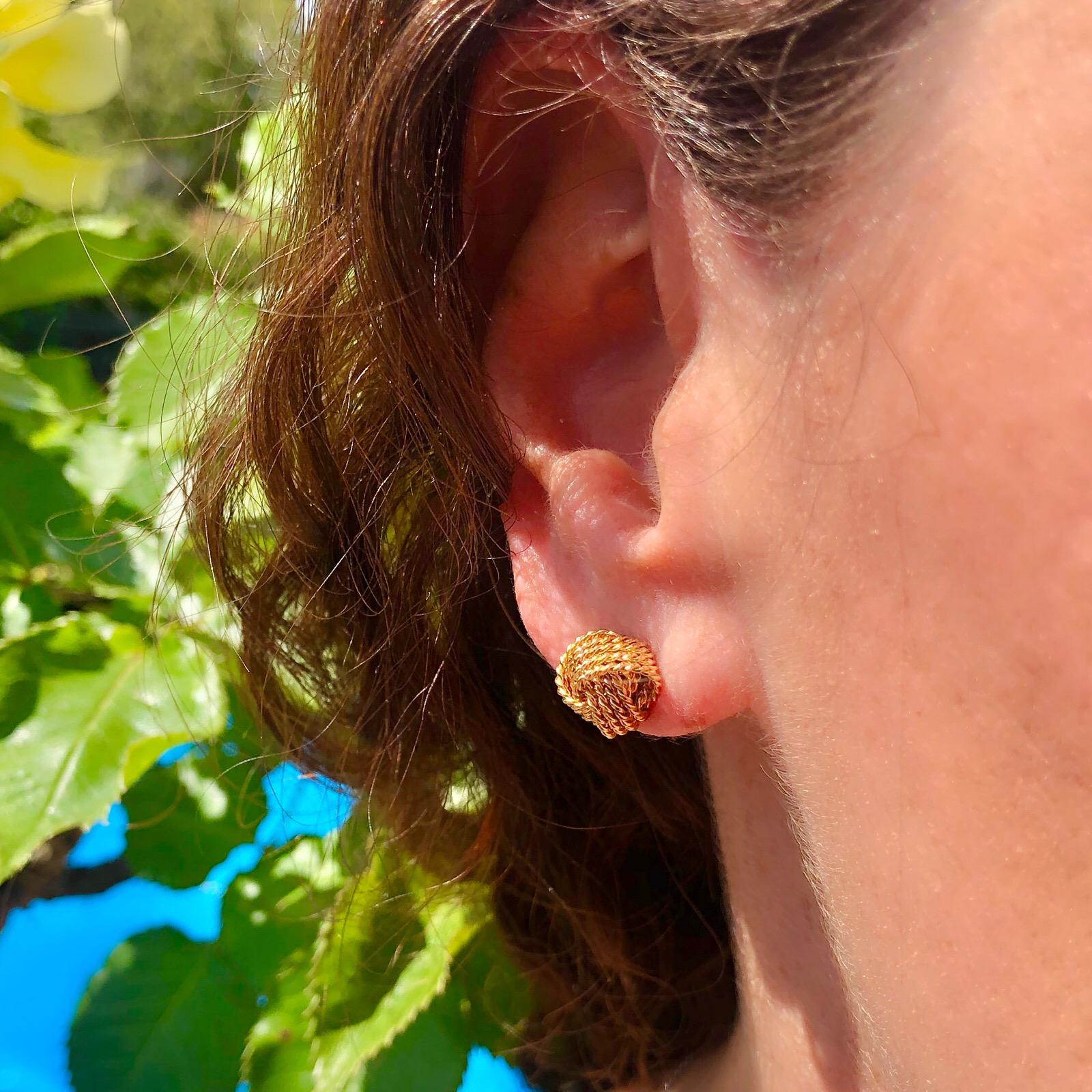 The perfect everyday earrings by venerable Tiffany & Co. The 18k gold knot design studs will add simple elegance to your outfit. Vintage 1970's, and still stylish today. The earrings weigh 4.5 grams, and the knots measure 3/8in in diameter. Timeless