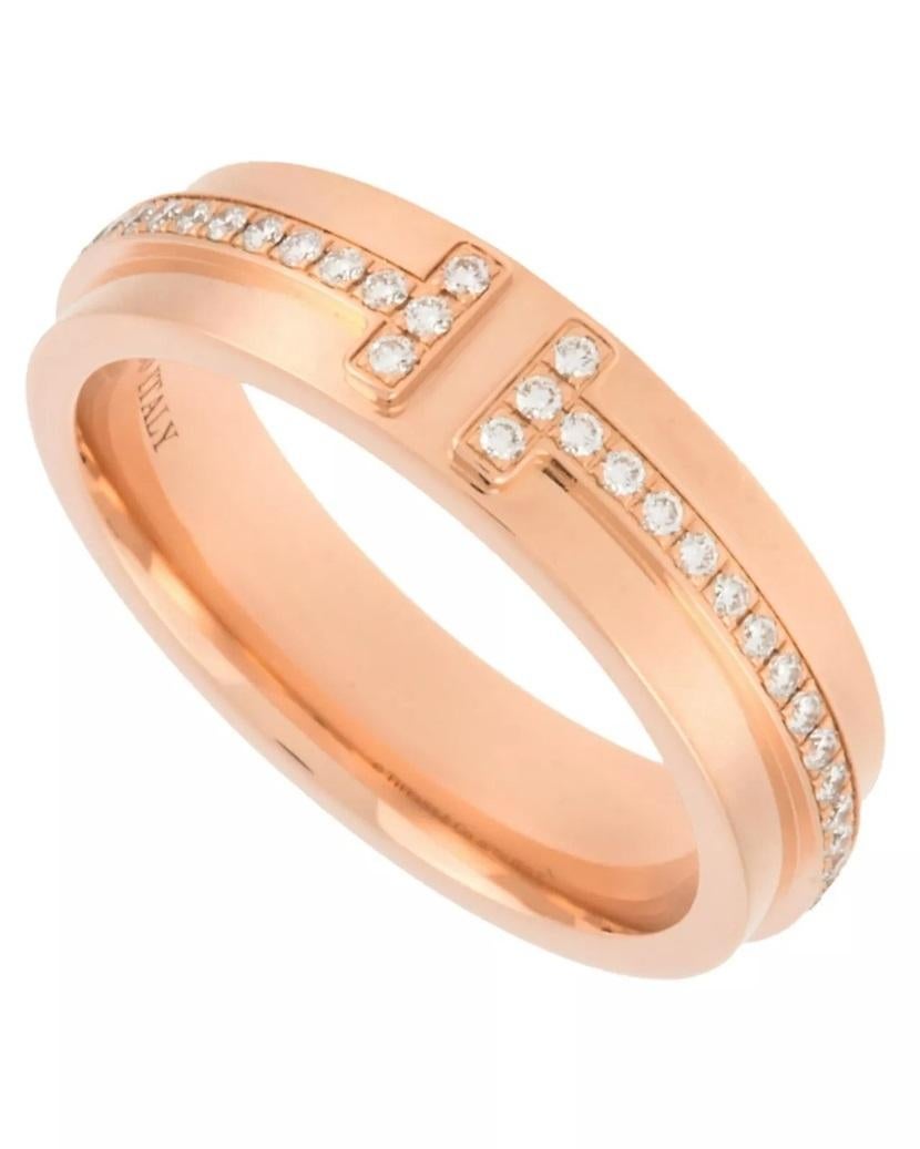 TIFFANY & Co. 18K Rose Gold 4.5mm Wide Diamond T Ring 7

Metal: 18K Rose Gold
Size: 7
Band Width: 4.5mm
Weight: 5.80 grams
Diamond: round brilliant diamonds, carat total weight .13 
Hallmark: ©TIFFANY&Co. Au750 ITALY
Condition: Excellent condition,