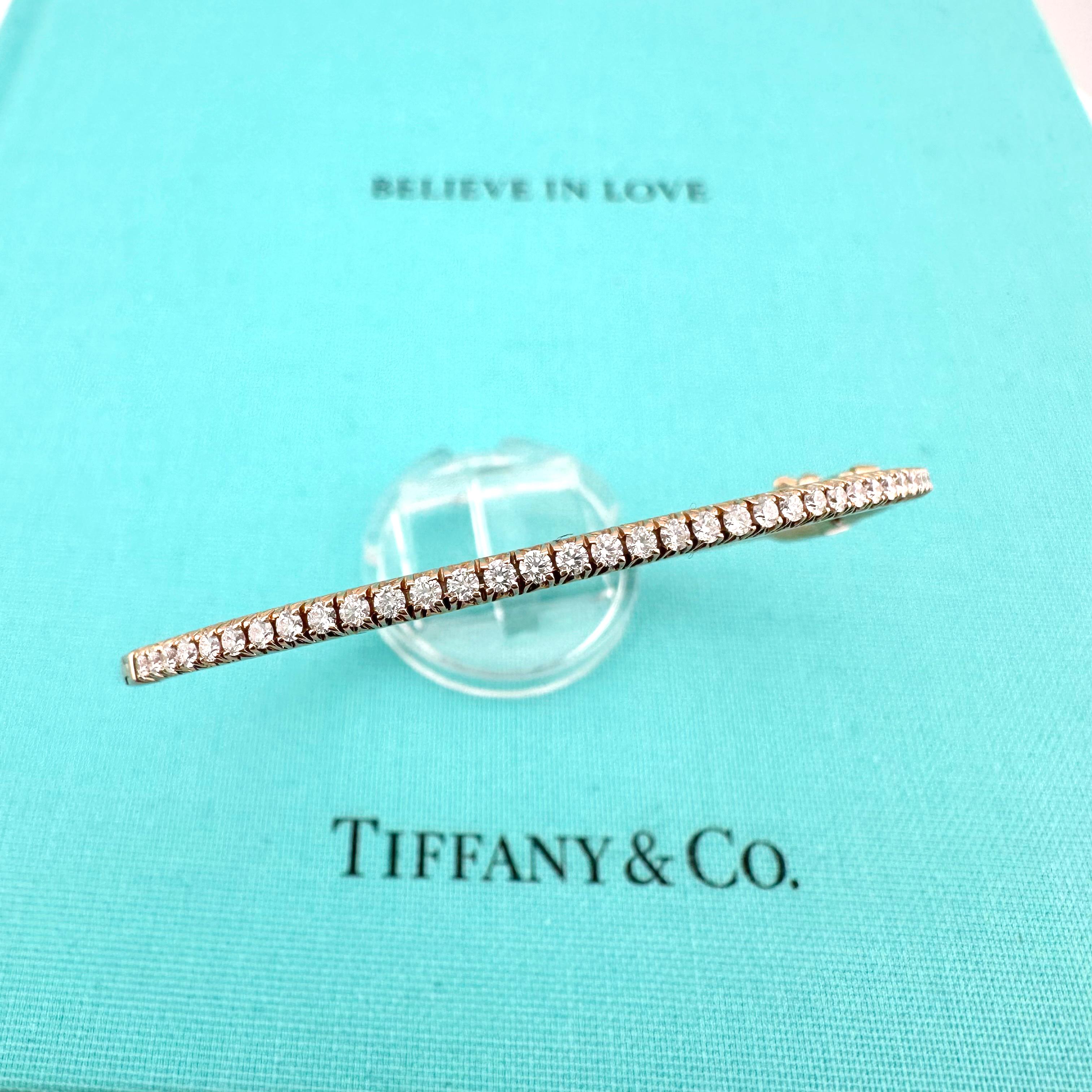 Tiffany Metro Diamond Hinged Bangle
Style:  Bangle
Ref. number:  6006146
Metal:  18k Rose Gold
Size:  Small - 6' Inches
TCW:  0.61 tcw
Main Diamond:  41 Round Brilliant Diamonds
Hallmark:  ©TIFFANY&CO. Au750 ITALY
Includes:  T&C JEWELRY