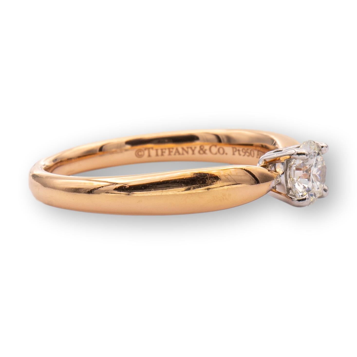 Tiffany & Co. engagement ring from the Harmony collection finally crafted in 18 karat rose gold with a round brilliant cut center diamond weighing 0.31 carats I color VS1 clarity. This ring is set in a platinum basket and rose gold tapered shank