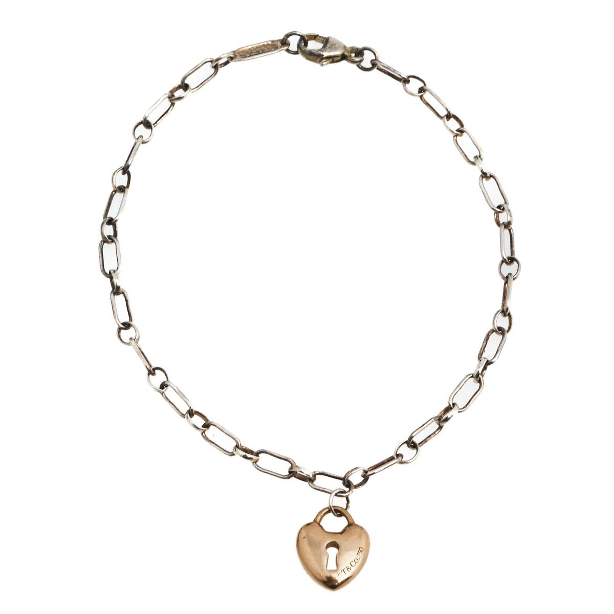 Let Tiffany's famous motif of a heart lock be yours through this bracelet. Crafted in silver, the bracelet has a chain-link holding an iconic Heart Lock charm, rendered in 18k rose gold, dangling beautifully. Unlock love today and every day when you