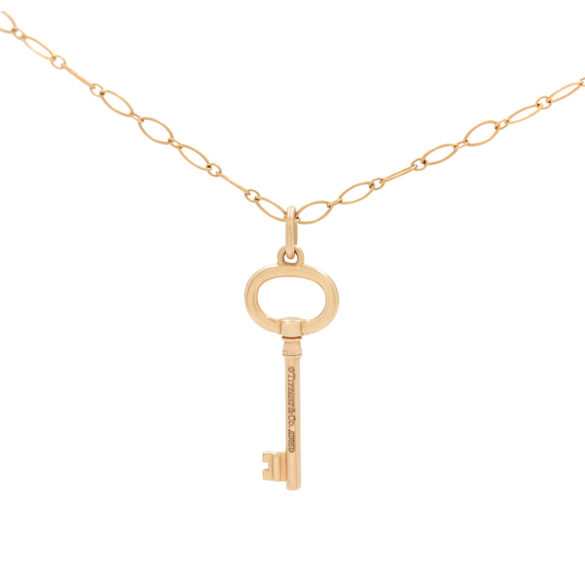 This 18k rose gold Tiffany & Co Key Pendant is completed by an 20 inches ball chain. Pendant size: 1.50 inches. Excellent pre-owned condition. Tiffany & Co hallmarked. Original box and papers are not included. 

