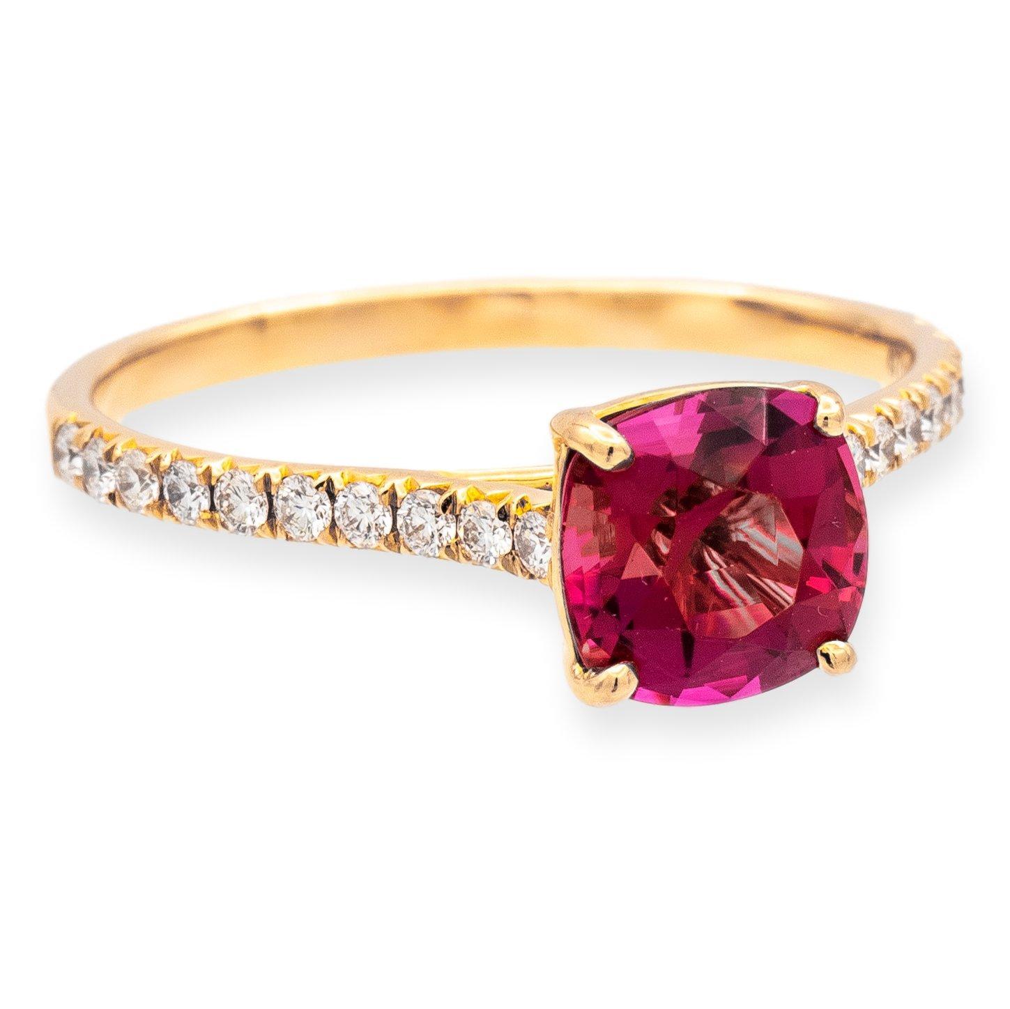 Tiffany & Co. ring from the legacy collection finely crafted in 18 karat rose gold featuring a cushion shape pink tourmaline center adorned with by a strip of bead set round brilliant cut diamonds going halfway down the shank and 2 round bezel set