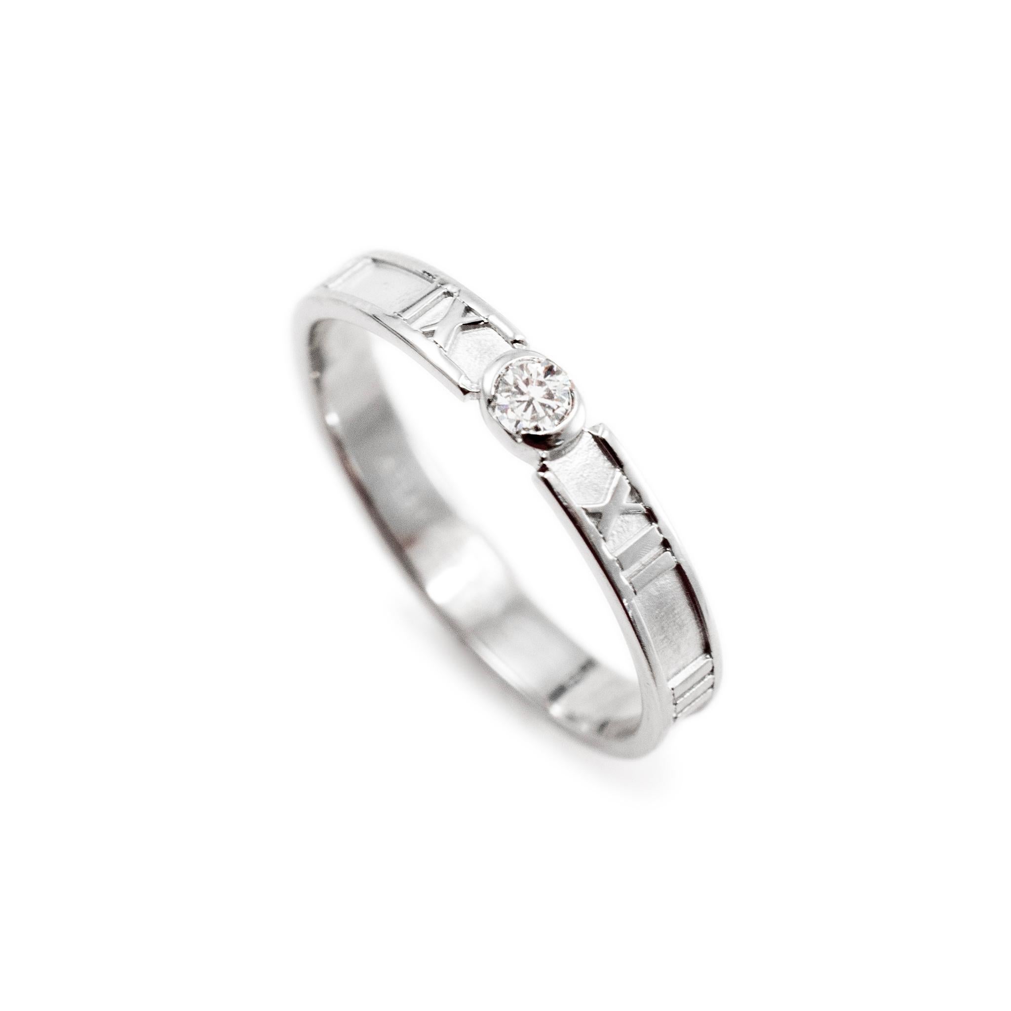 Brand: Tiffany & Co.

Metal Type: 18K White Gold

Ring Size: 9.75 

Width: 3.40 mm

Weight: 3.27 grams

One 18K White Gold diamond solitaire band with a soft-square shank. The metal was tested and determined to be 18K white gold. Engraved with
