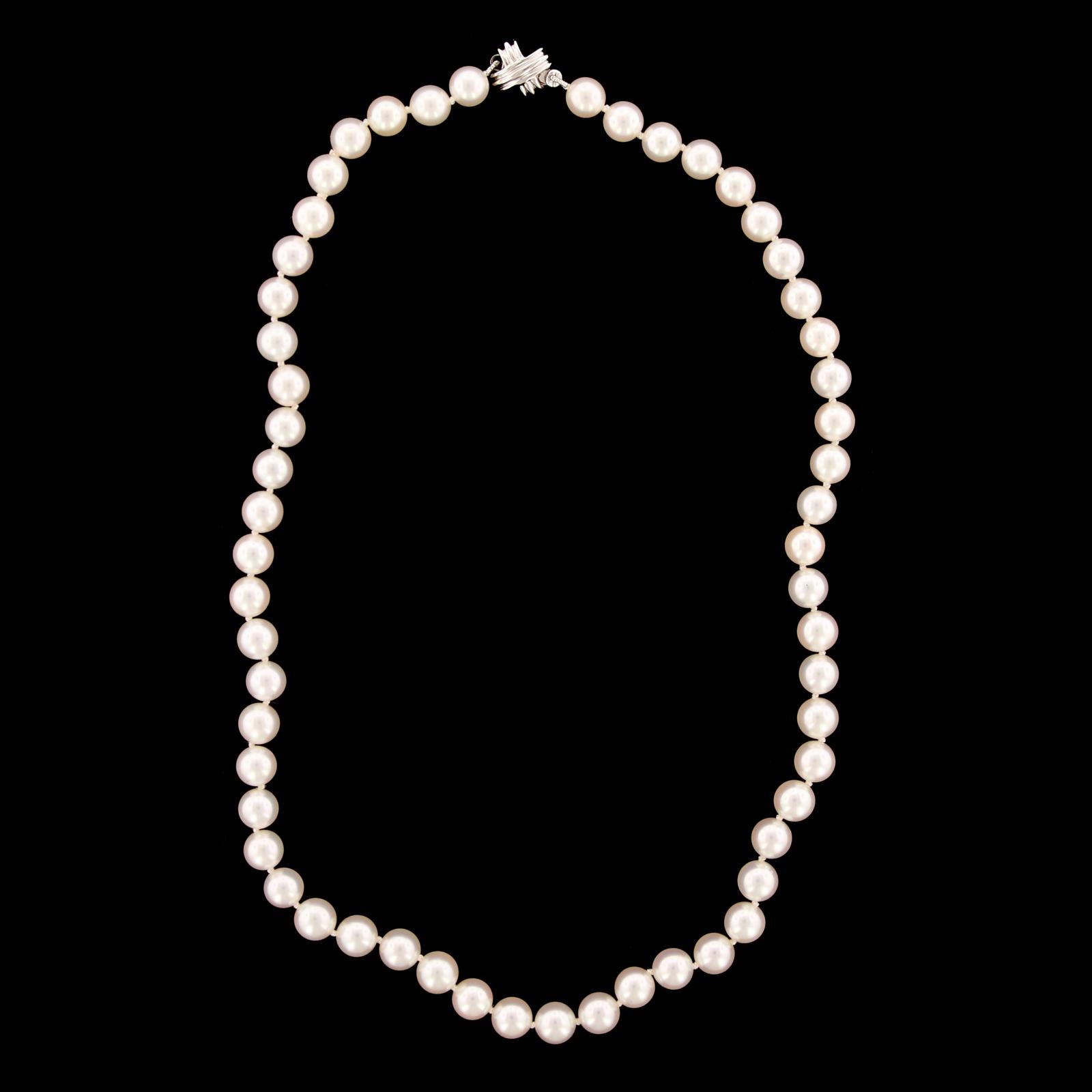 Tiffany & Co. Cultured Pearl Necklace. The necklace is comprosed of 56 cultured
pearls each measuring 6.50 to 7.00mm., completed by an 18K white gold signature
clasp, length 16