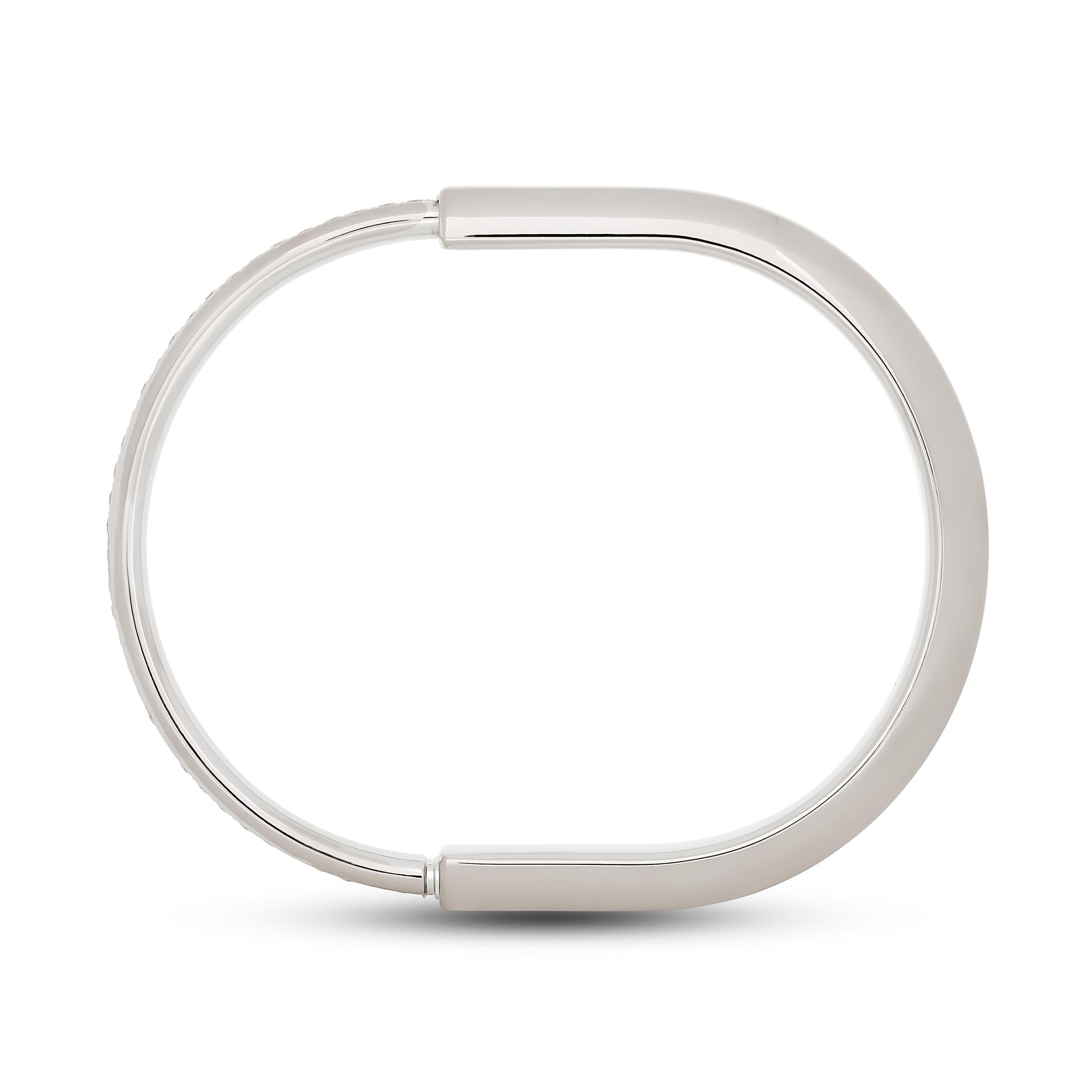 This elegant Tiffany & Co. 18k white gold Lock bangle features a sleek, modern silhouette inspired by archival padlocks, accented with a glittering row of round brilliant diamonds across the front.

There are 36 round diamonds that weigh