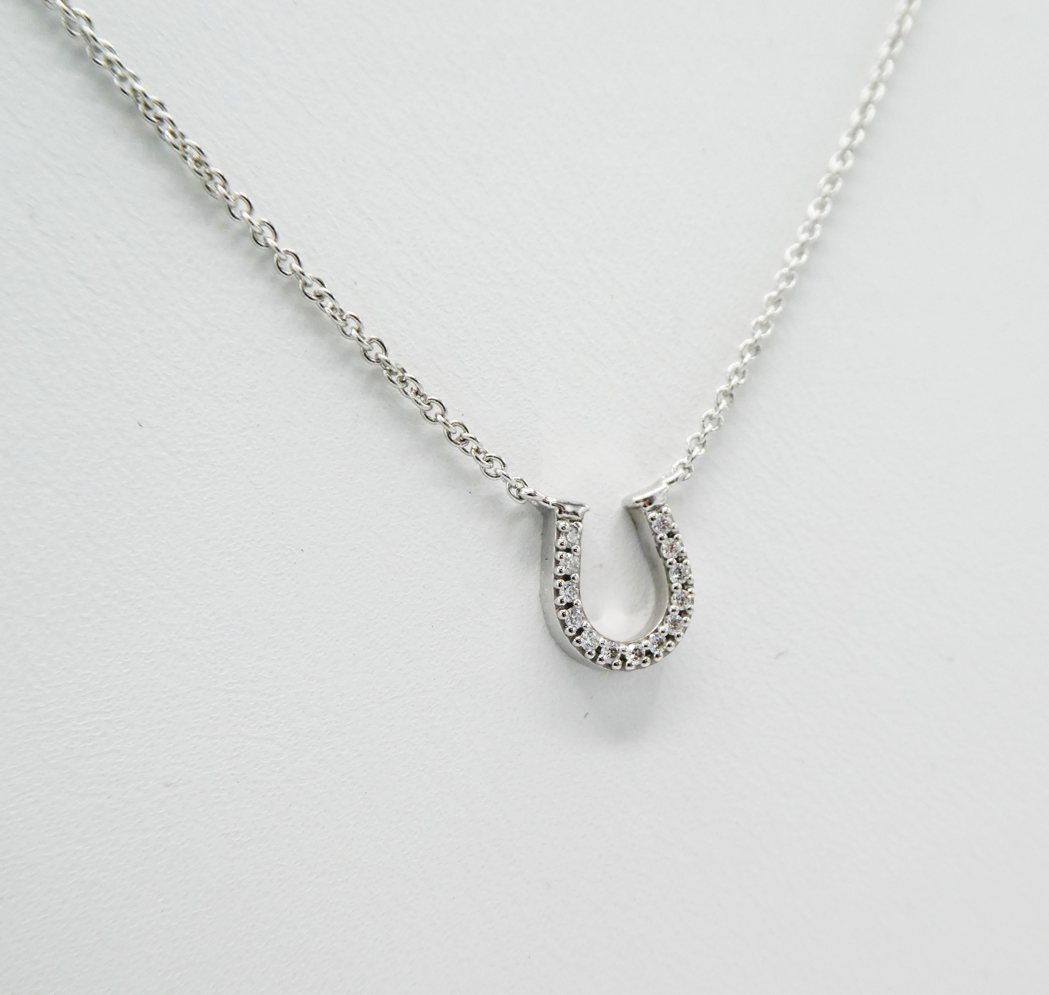Tiffany & Co. 18K White Gold Pave Diamond Horse Shoe Pendant Necklace .08 CTW Diamonds, 16 inches. 

Metal: 18k White Gold
Weight:  2.02 grams
13 Round Brilliant Cut Diamonds weighing approximately .08 CTW G VS
Chain Length: 16 inches
Stamped: