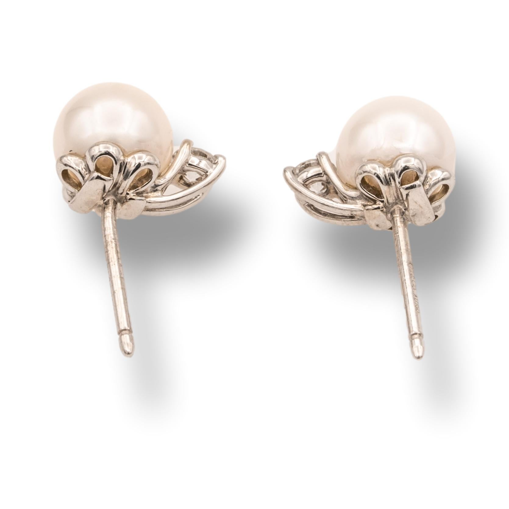 Tiffany & Co. Signature Pearl Stud Earrings finally crafted in 18 karat white gold with with 2 diamonds set in prongs weighing 0.16 carats total. The pearls have a pinkish luster and measure 7-7.5 mm with friction back posts and butterfly backs.