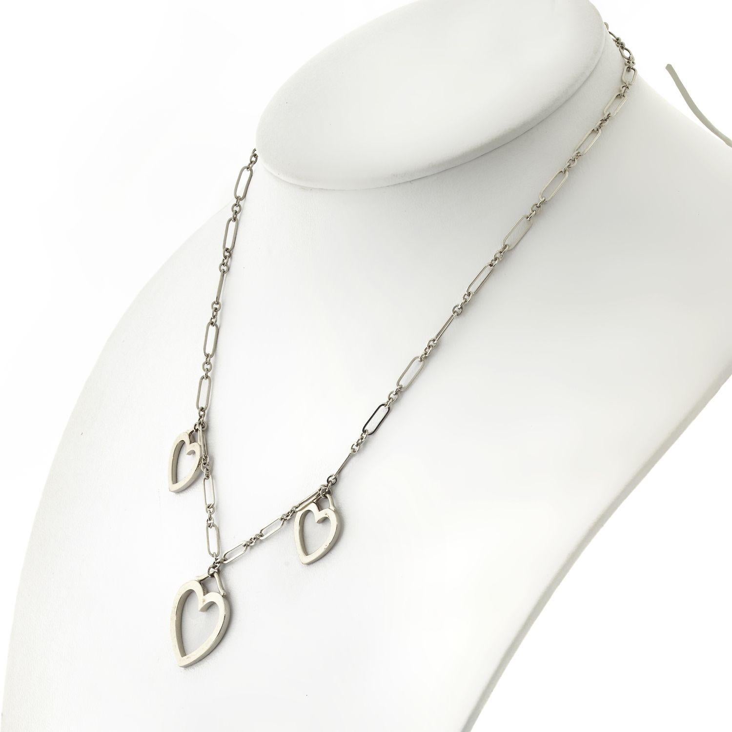 Tiffany & Co. 18K White Gold Triple Sentimental Heart Pendant Necklace. This authentic Tiffany & Co. piece is finely crafted from solid 18k white gold. It features a unique chain link design along with 3 beautiful heart pendants which look great on