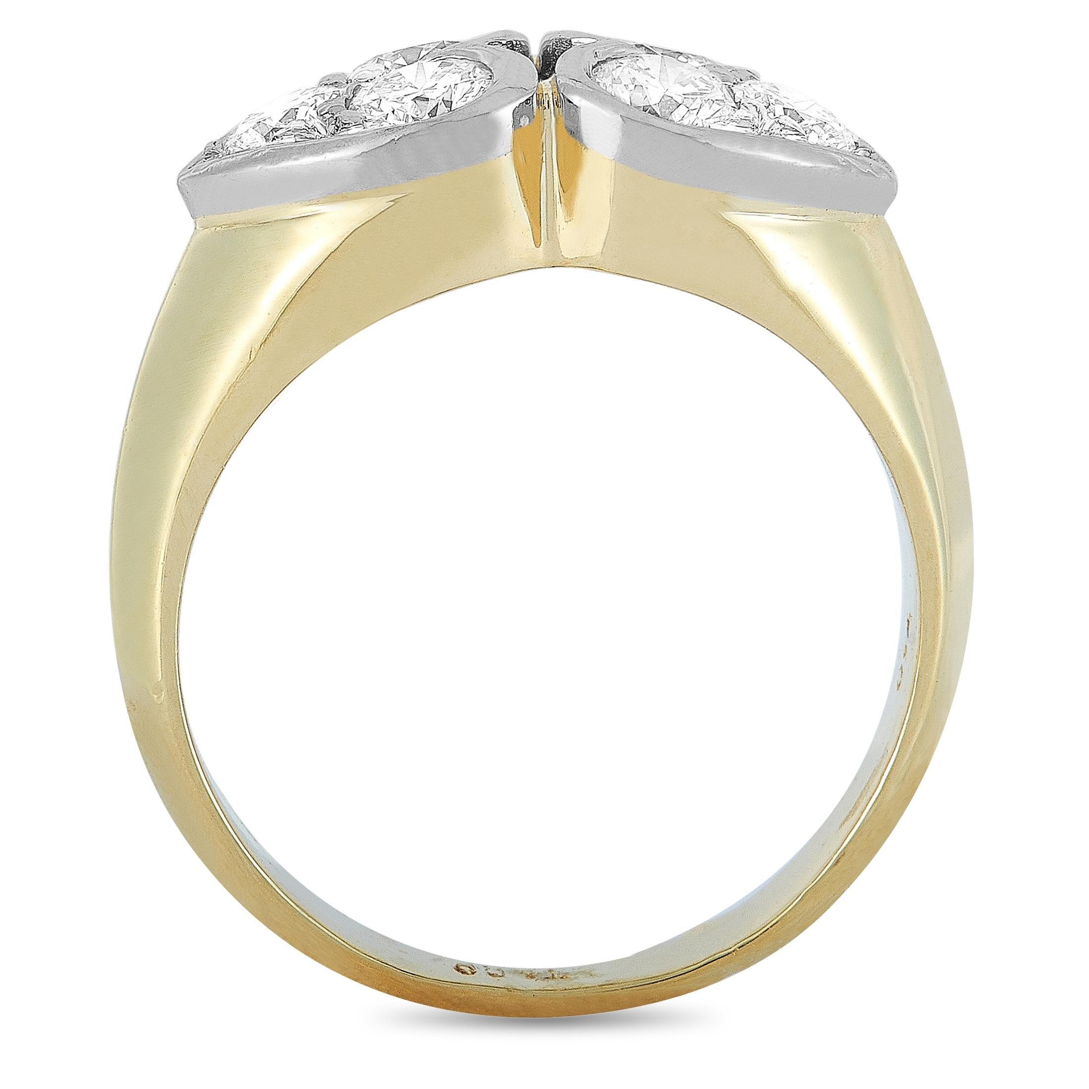 This Tiffany & Co. ring is made out of 18K yellow and white gold and weighs 5.3 grams. It boasts band thickness of 2 mm and top height of 4 mm, while top dimensions measure 15 by 8 mm. The ring is set with diamonds that feature grade F color and VS1