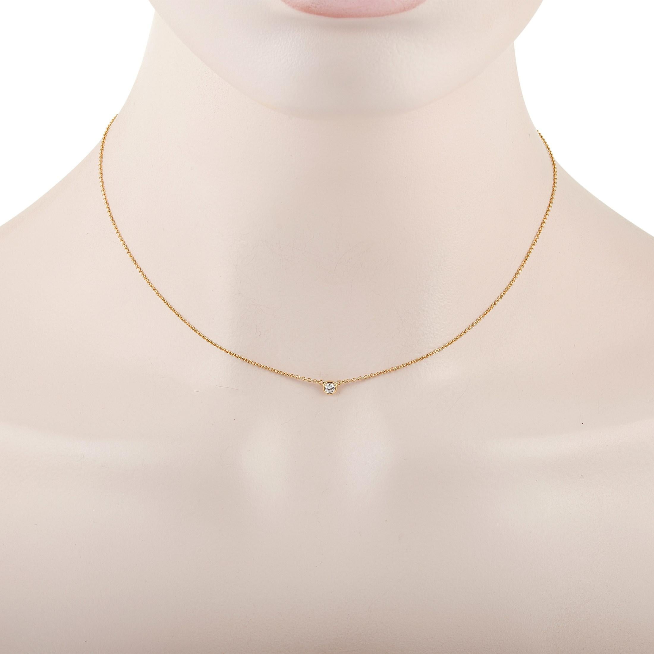 This classic Tiffany & Co. 18K Yellow Gold 0.10 ct Diamond necklace is made with 18K yellow gold and features a solitary 0.10 carat bezel-set diamond pendant. The delicate 18K Yellow Gold Chain measures 15 inches in length and features a spring-ring