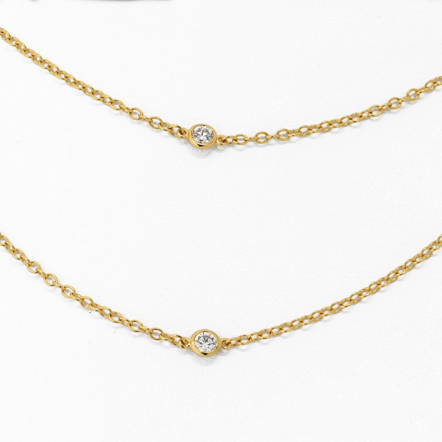 The 18k yellow gold Tiffany & Co Diamond by the Yard Chain is a stunning piece of jewelry that is both timeless and elegant. This chain is crafted from high-quality 18k yellow gold and features 10 round cut diamonds that are set along the length of