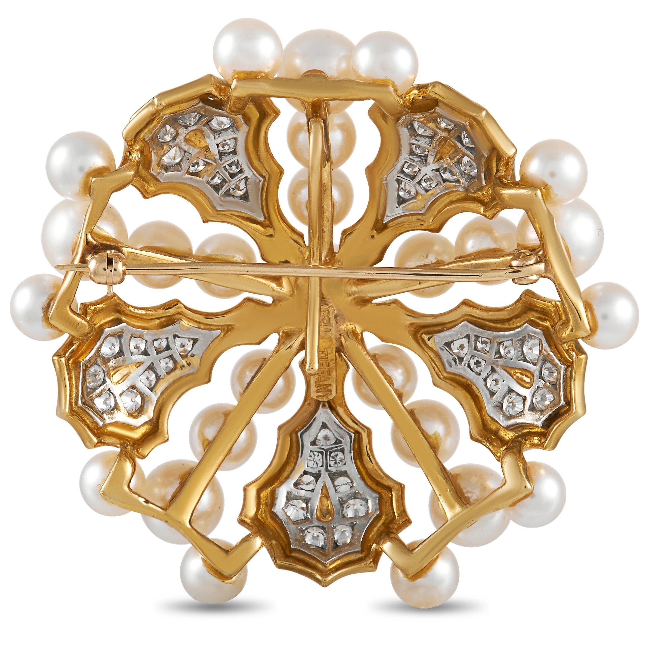 Add drama and elegance to any ensemble with the help of this iconic Tiffany & Co. brooch. This symmetrical piece pairs exquisite pearls with 1.50 carats of diamonds with E color and VVS clarity. This stunning accessory is crafted from 18K Yellow