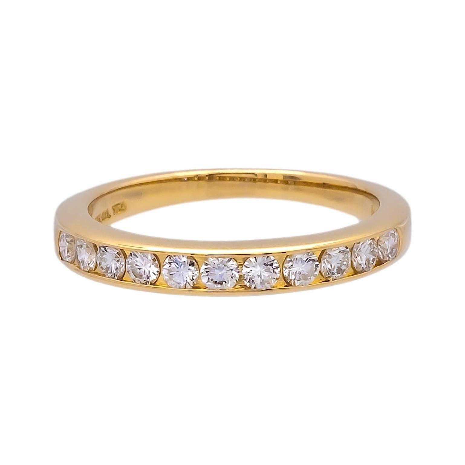 Tiffany & Co Channel set Wedding/Anniversary band finely crafted in 18K yellow gold with 11 round brilliant cut diamonds weighing 0.33 cts. total weight ranging in near colorless F-G color and VVS clarity set in a halfway channel measuring 3mm wide.