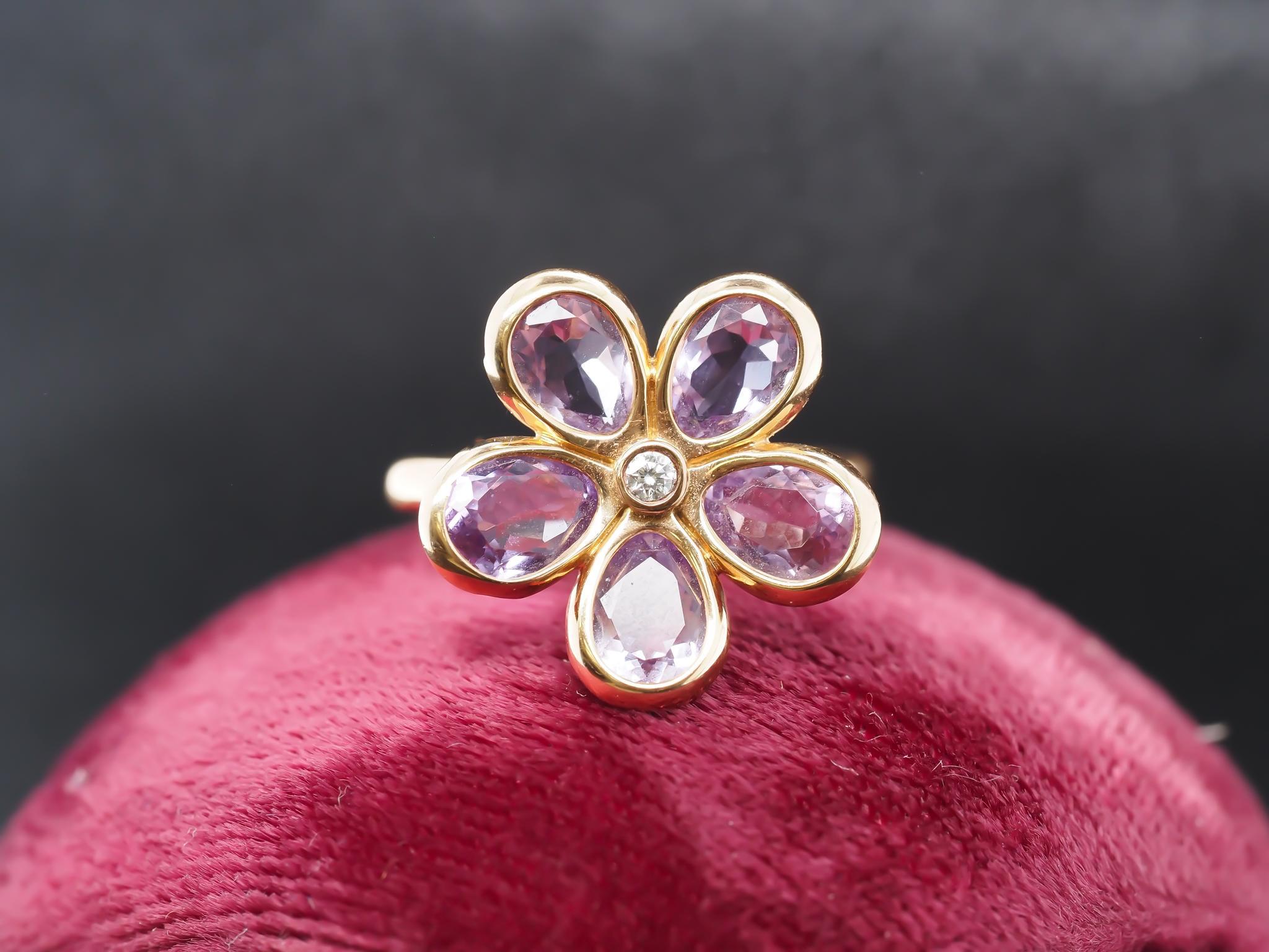 Year: 2000s
Item Details:
Ring Size: 7.25   (Sizable)
Metal Type: 18K Yellow Gold [Hallmarked, and Tested]
Weight:  5.1 grams
Diamond Details: Round Brilliant, Natural Diamond, .05ct, F Color, VS Clarity.
Side Stone Details: Amethyst, Pear