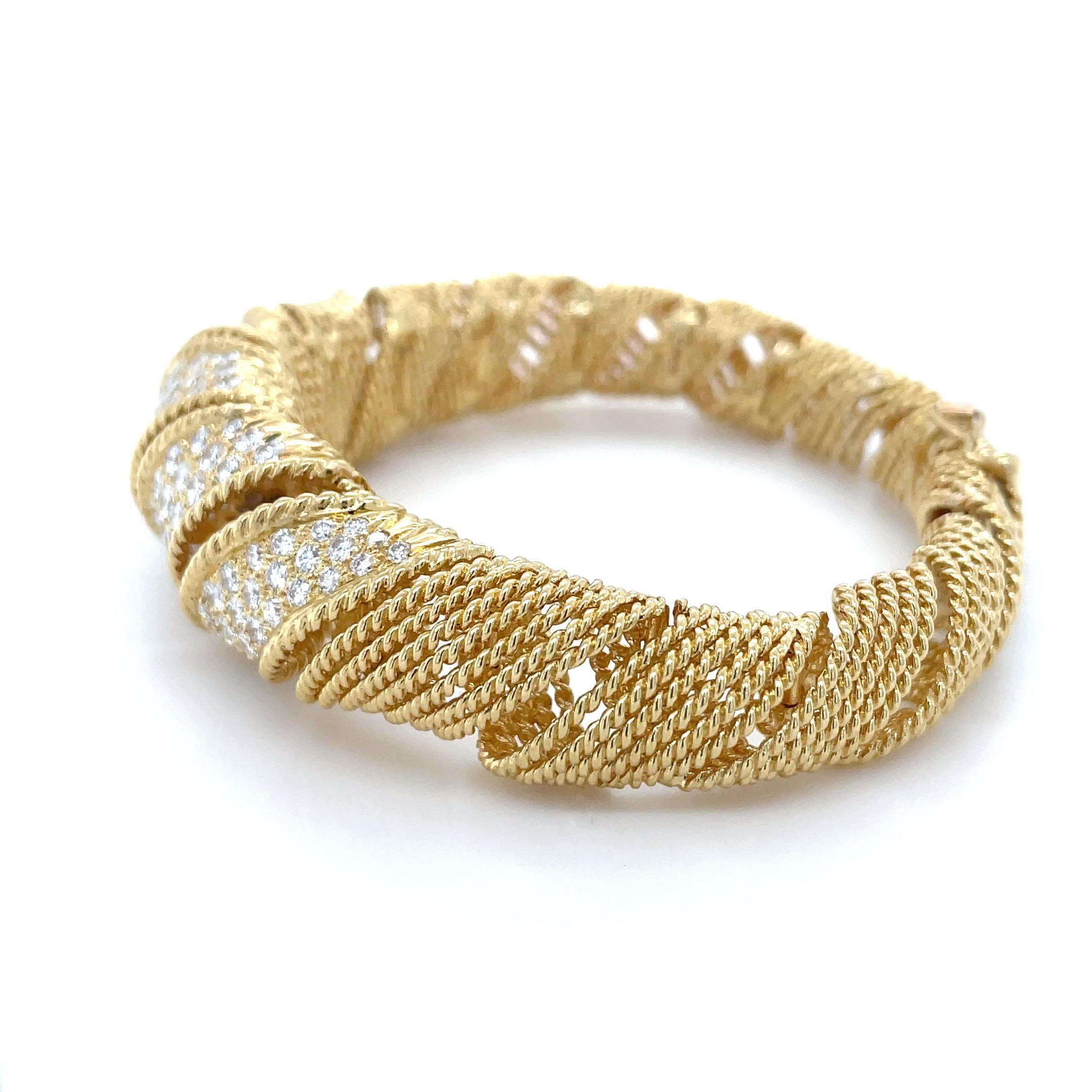 In an open work ribbon motif, this stunning bracelet by Tiffany & Co. boasts 141 top quality round brilliant cut diamonds weighing approximately 8.00 carats total. Mounted in 18 karat yellow gold and skillfully crafted, this bracelet is perfect for