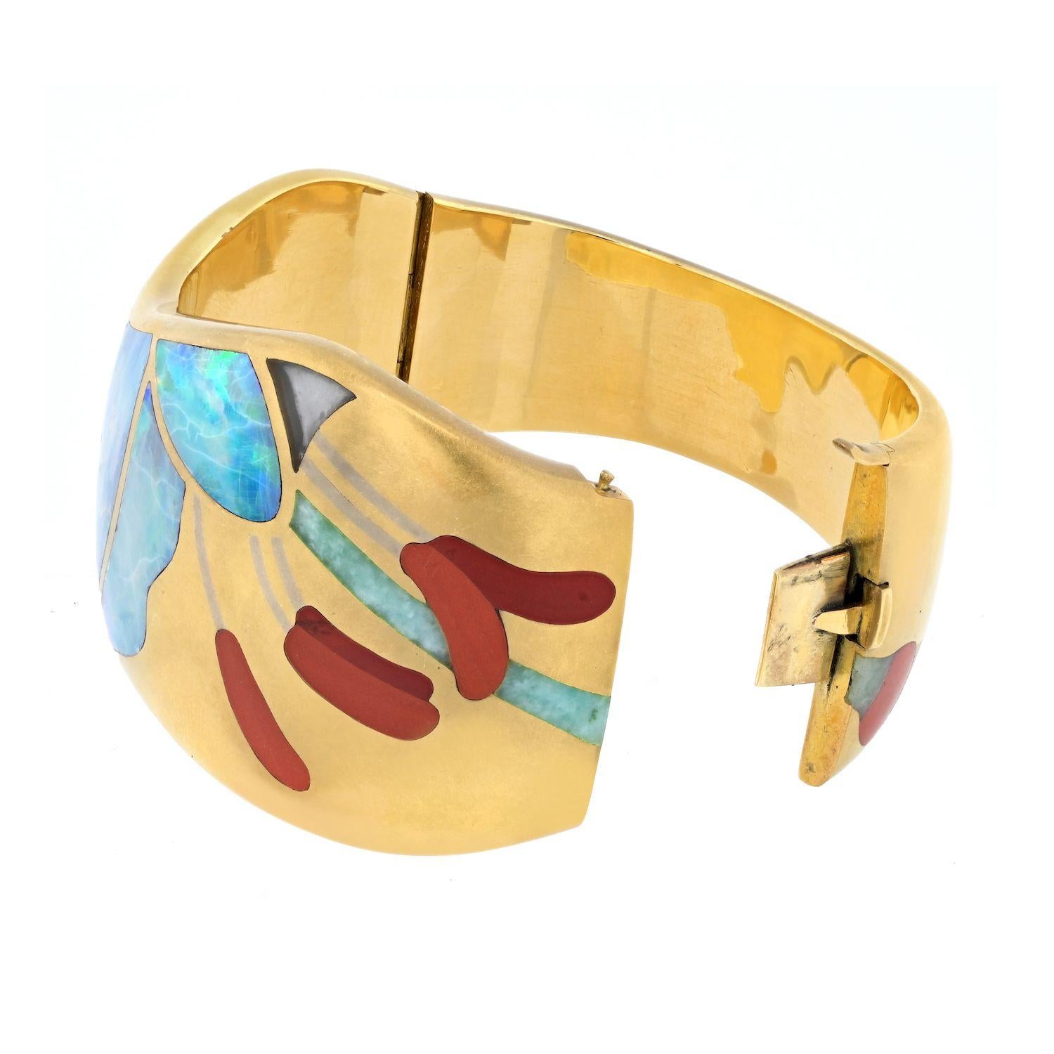 Elevate your jewelry collection with the exquisite Tiffany & Co. 18K Yellow Gold Angela Cummings Opal Bracelet. This stunning piece is a testament to Angela Cummings' exceptional artistry, showcasing inlaid opal, carnelian, rock crystal, and green