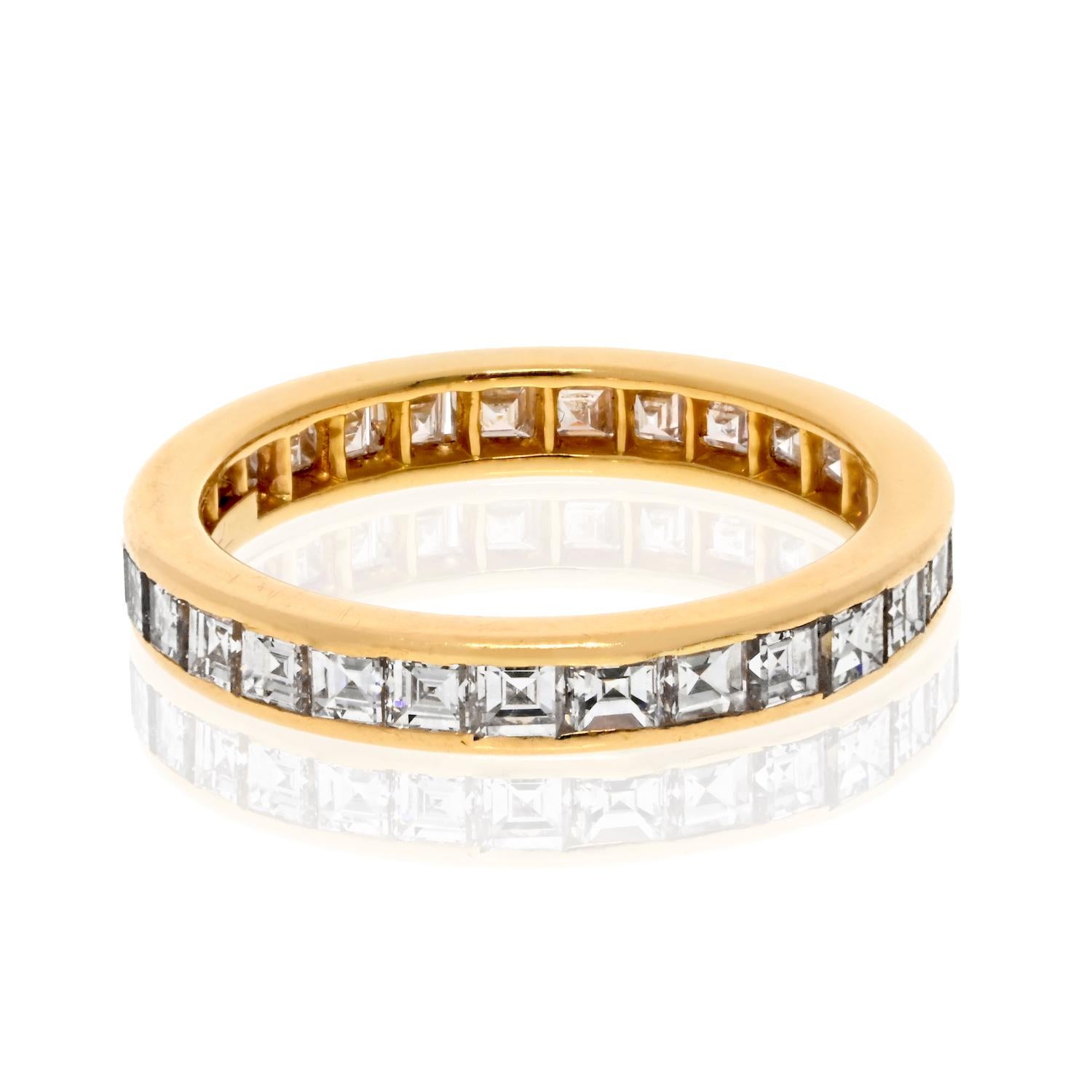 This Tiffany & Co. 18k Yellow Gold Eternity Band is a breathtaking example of classic luxury. Adorned with 29 straight-cut Asscher diamonds, totaling 3.00 carats, each stone is expertly set to maximize brilliance and capture light from every angle.