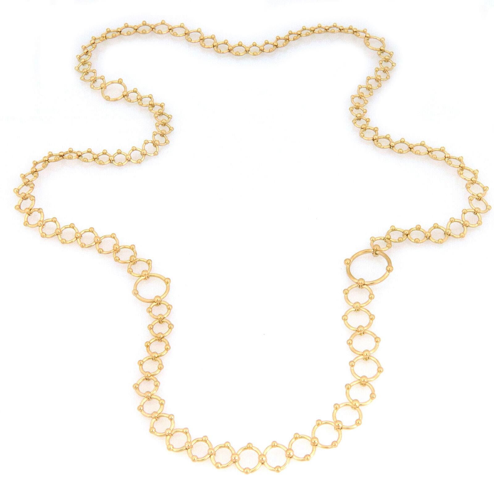This is a gorgeous authentic necklace from Tiffany & Co. Crafted from 18k yellow gold with a fine polished finish featuring assorted open ring links, each joined together by a double side fine bead clamp, the long necklace has one large ring link