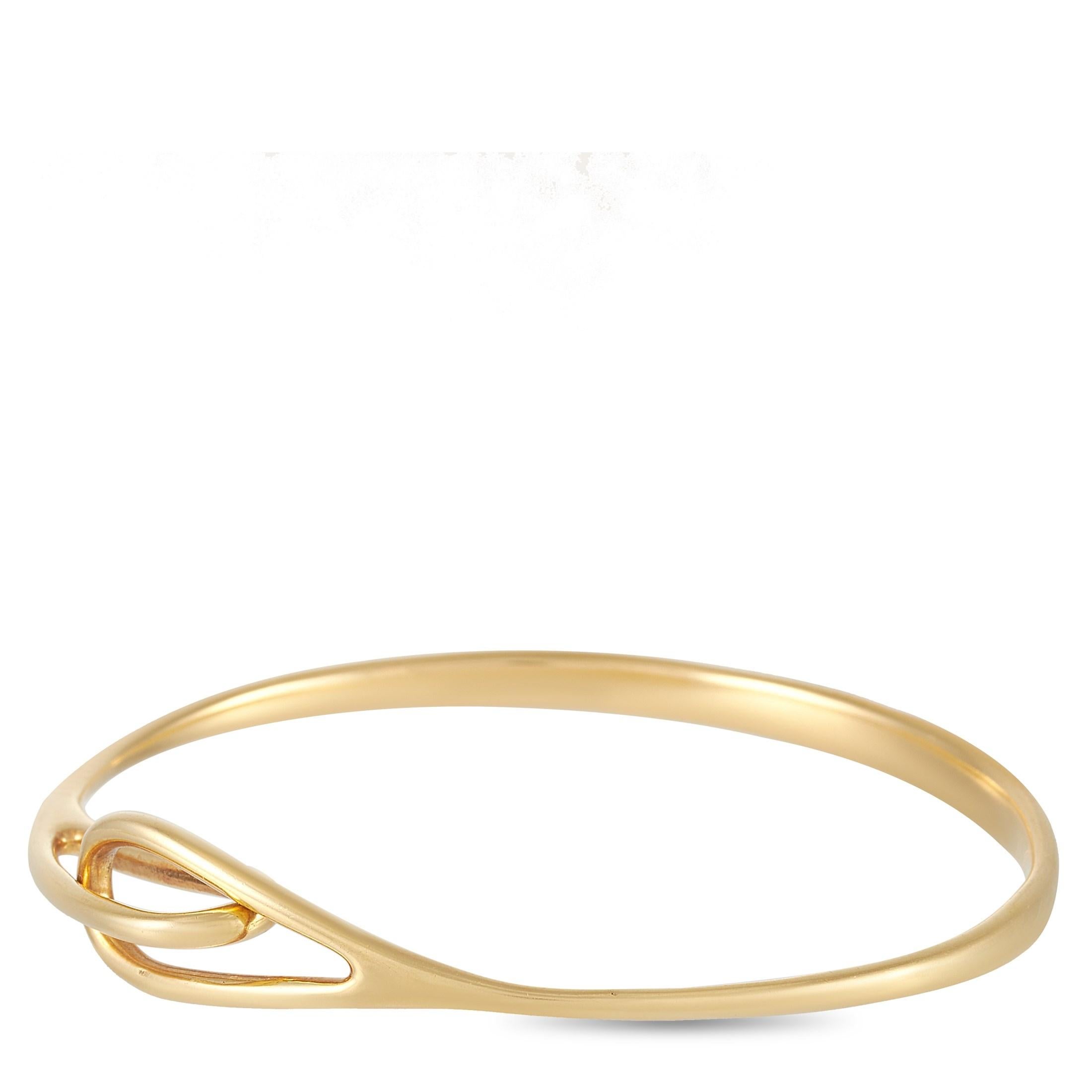 This Tiffany & Co. 18K Yellow Gold Bangle Bracelet is simple but pretty, the bangle measures 7.85 inches in diameter and links together in the front. The bangle weighs a total of 21.8 grams. 

This bracelet is presented in estate condition and