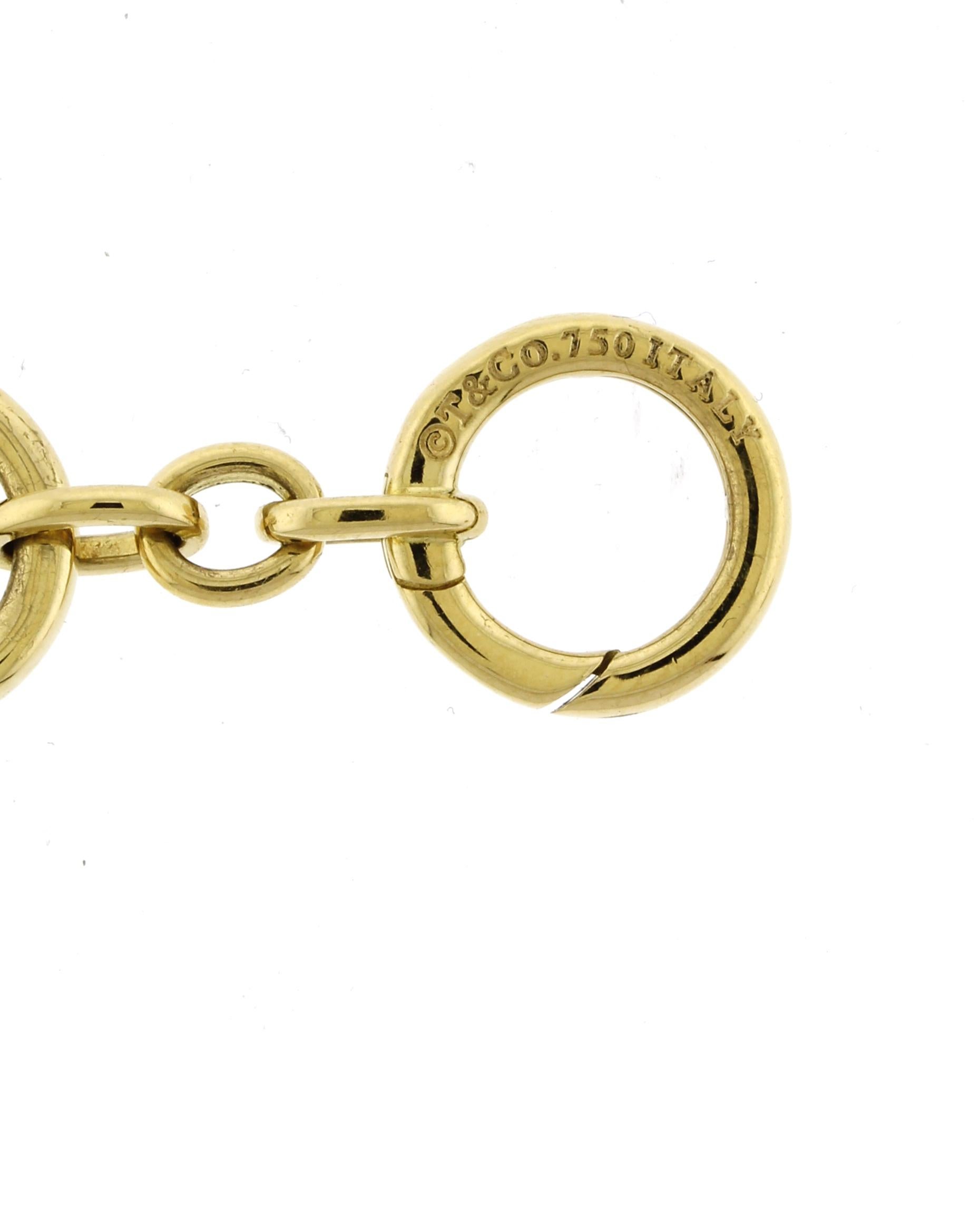 Tiffany & Co. 18k Yellow Gold Charm Bracelet with Diamond Egg Locket Unisexe en vente